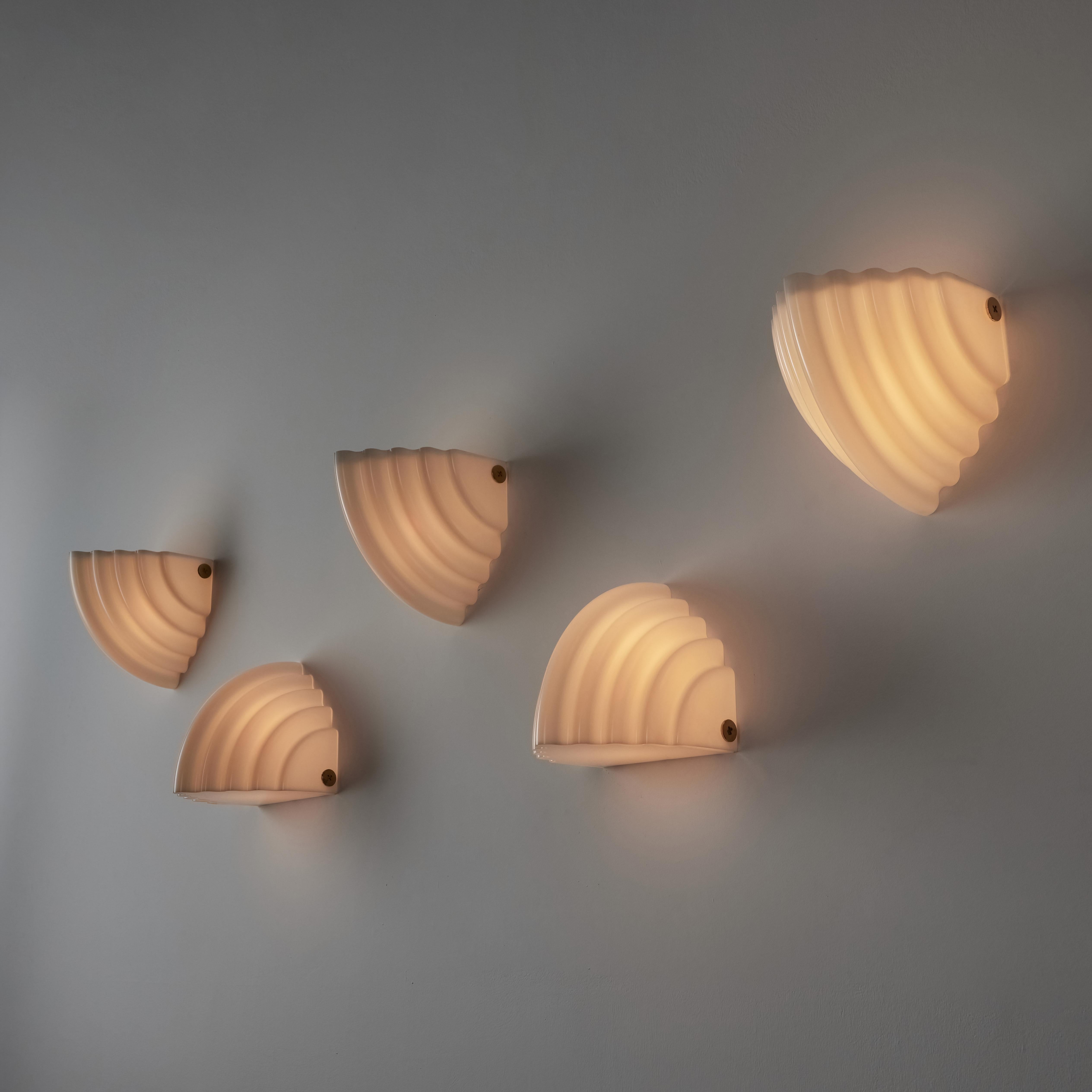  'Kai 2' sconces by Kazuhide Takahama for Sirrah. Designed and manufactured in Italy, circa the 1980s. Mollusc shaped molded acrylic shells make up the entire body of these contemporary sconces. As shown in the imagery, you are able to mount these