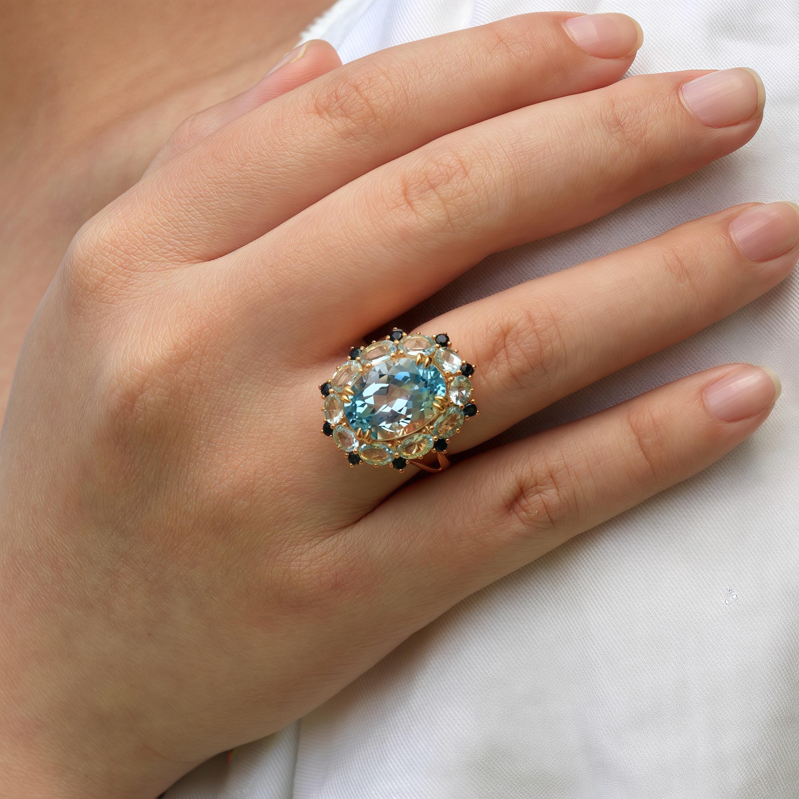 Discover Kai Blue Topaz Aquamarine Sapphire Cluster Cocktail Ring in 14k yellow gold, a true masterpiece of elegance and sophistication. This exquisite piece of jewelry showcases a stunning 7.20-carat topaz at its center, radiating a mesmerizing