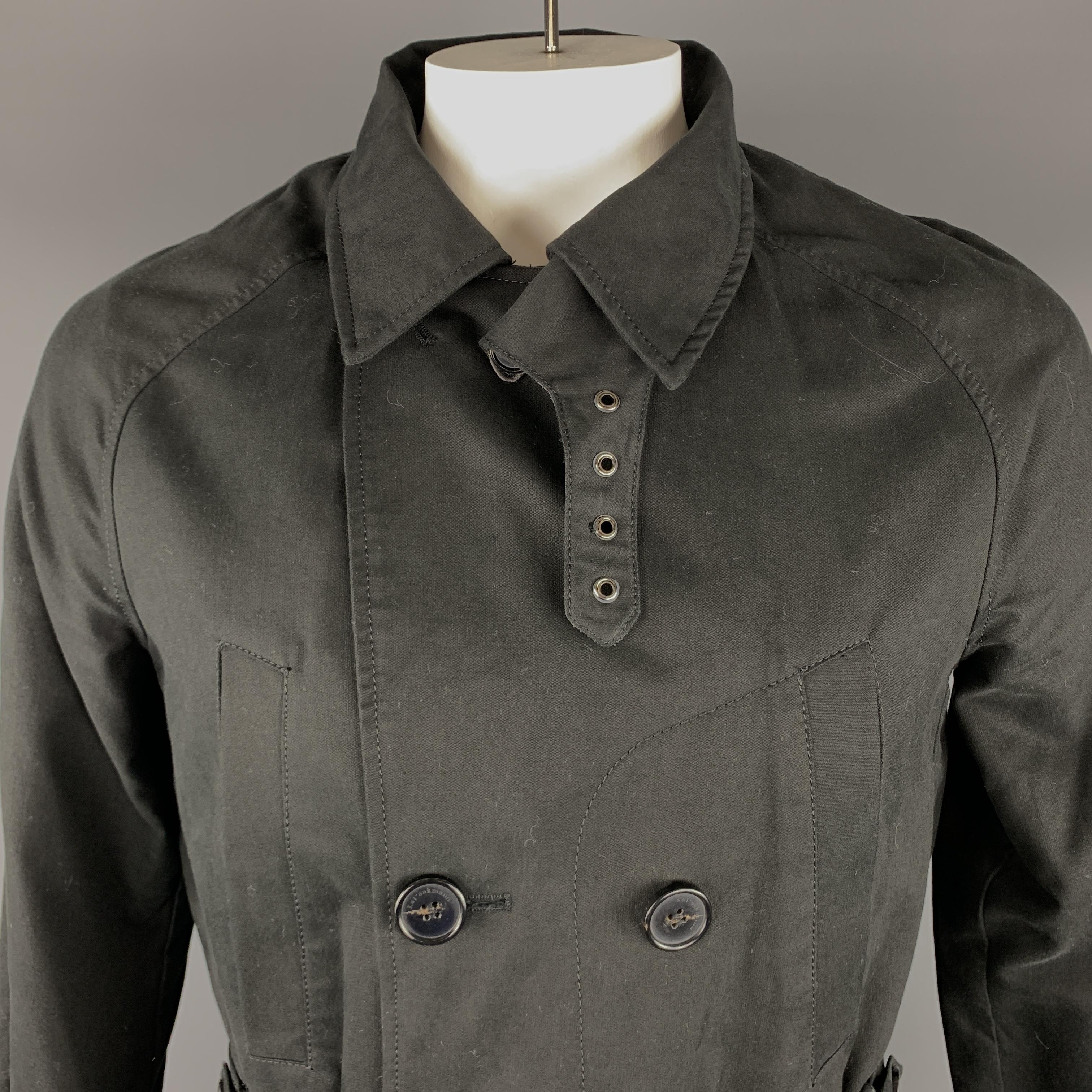 KAI AAKMANN Trench coat comes in a black tone in a solid cotton material, with a peak lapel, raglan sleeves, slit pockets, belted cuffs, double breasted, a single vent at back and a detachable lining.
 
Excellent Pre-Owned Condition.
Marked: L
