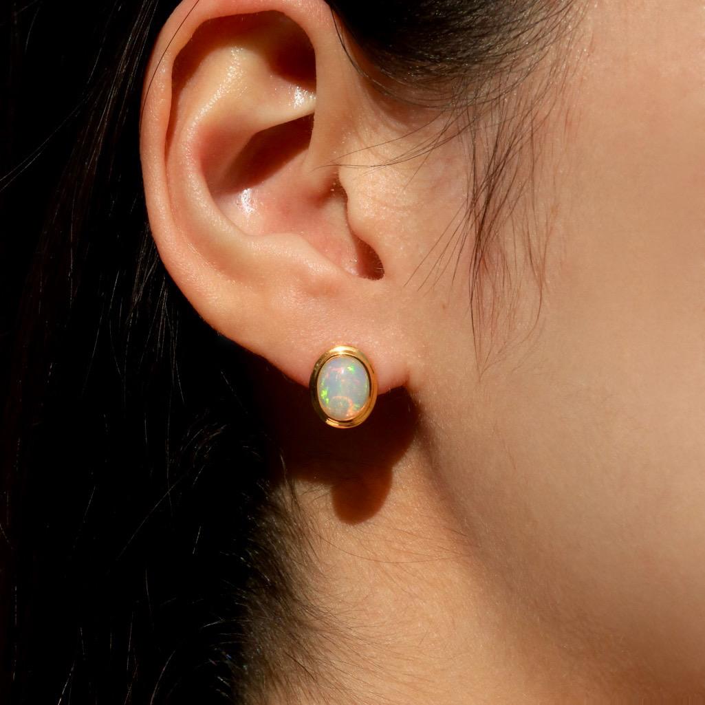 The ethereal opals, known for their enchanting play-of-color, show a captivating glow that shifts beautifully with every turn. Each opal is cut into an oval shape, enhancing its natural brilliance and charm.

Kai Bella Oval Fire Opal Earrings embody