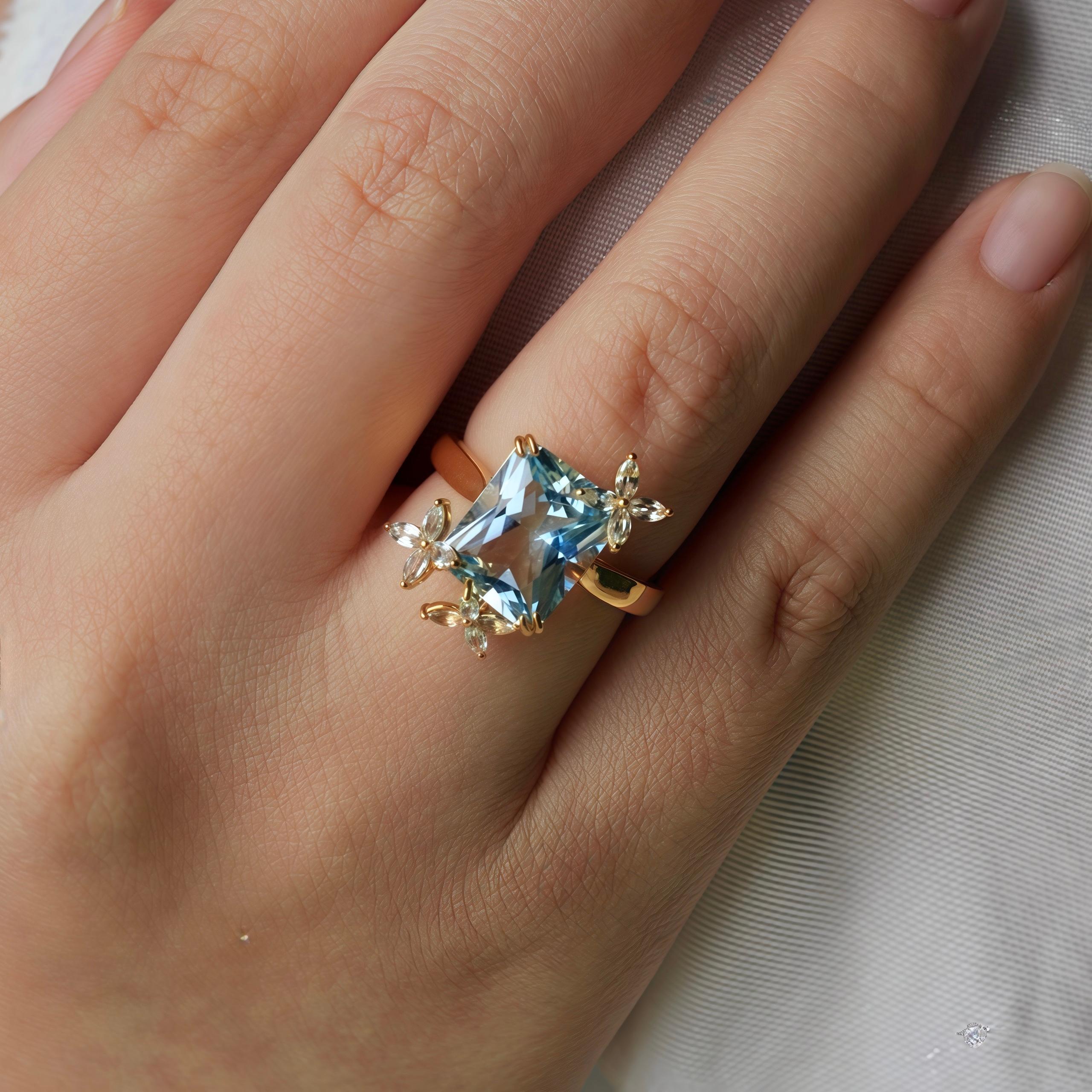 La bague cocktail Kai Blue Topaz Sapphire Butterfly capture la beauté délicate de la nature dans un design luxueux. En son cœur se trouve une topaze bleue suisse de taille radieuse, d'une brillance sereine rappelant les cieux clairs. Autour de la