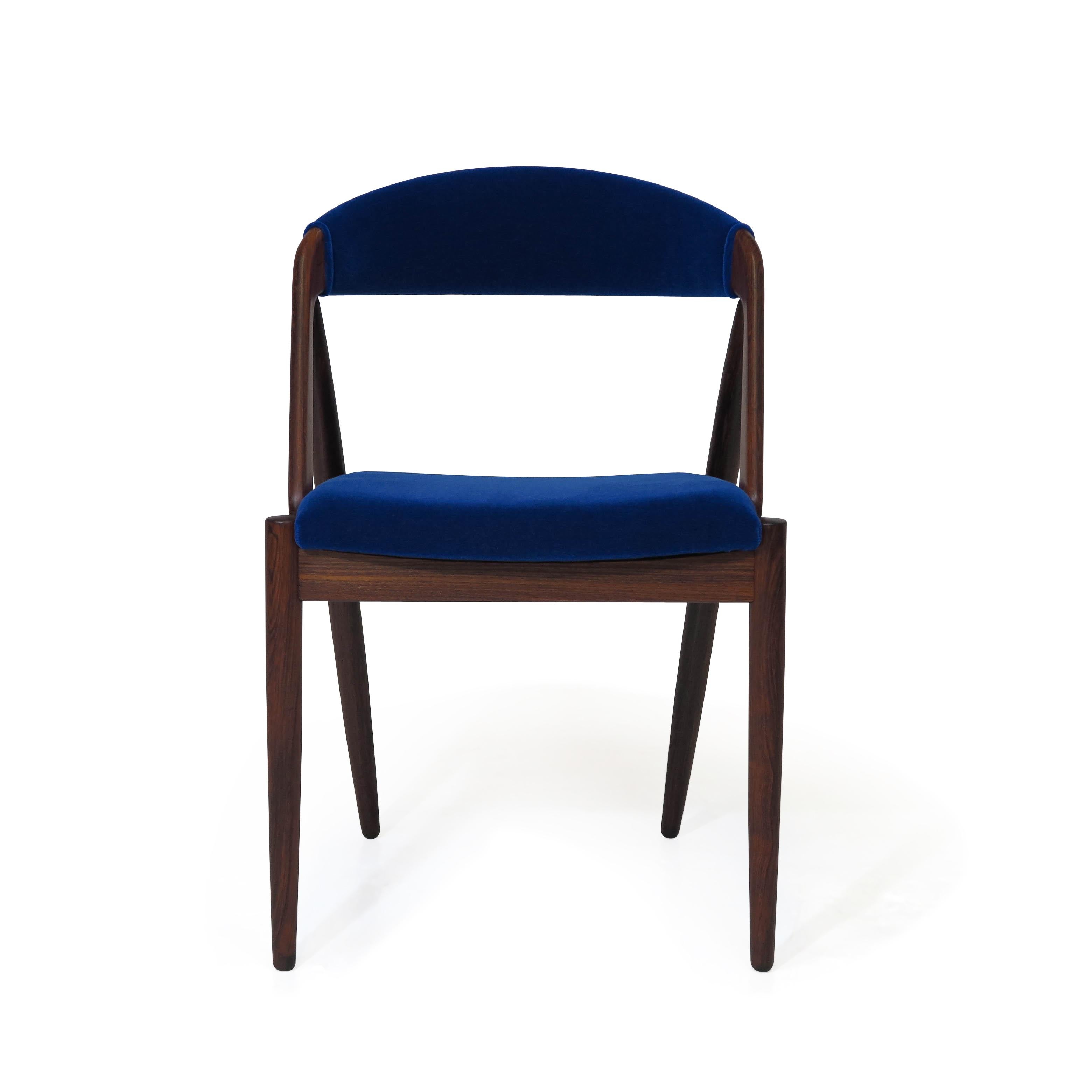 Set of four rosewood dining chairs designed by Kai Kristiansen for Schou Andersens Mobelfabrik, model 31 circa 1956 Denmark. Crafted of solid Brazilian rosewood upholstered in cobalt blue mohair. The seat frames constructed of a wood frame with