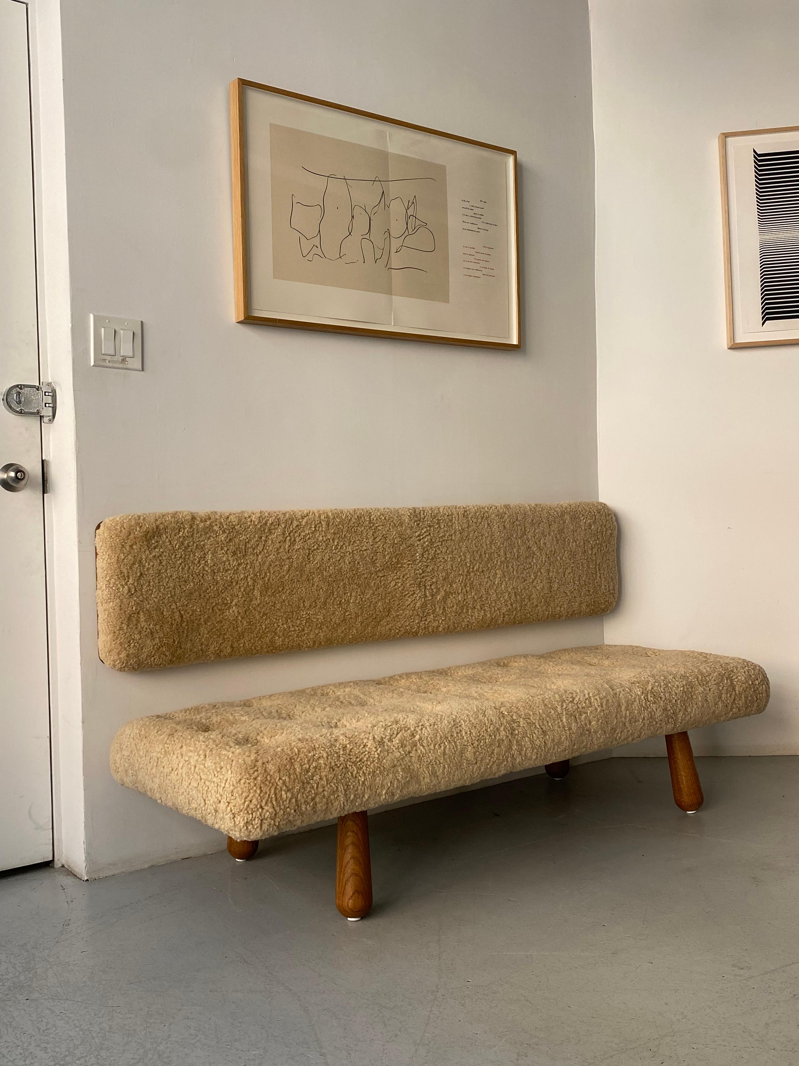 Beautiful contemporary couch with floating wall-mounted back which can be installed at the height of your choosing. Great for use in common spaces such as living rooms, hallways, and dining areas. The comfortable shearling is also great in private