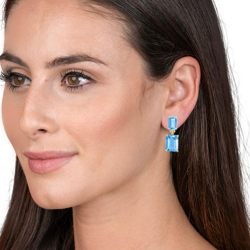 Kai Emerald-Cut 9ct Swiss Blue Topaz Diamond Drop Earrings in 14k Yellow Gold are an embodiment of elegance and refined taste. These stunning earrings feature a pair of exquisite 9-carat Swiss blue topaz stones, each meticulously emerald-cut to