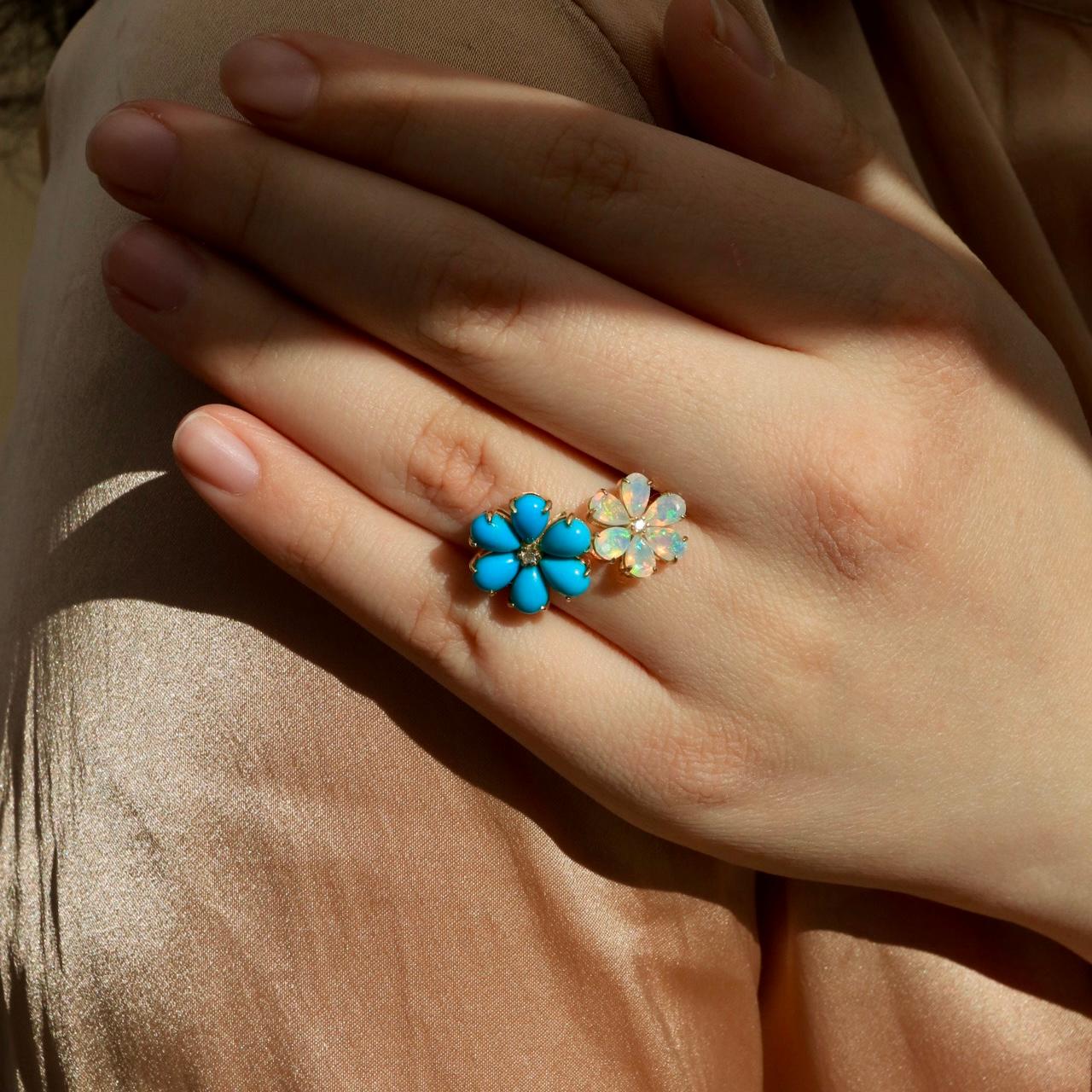 A masterful blend of natural beauty and refined craftsmanship, the Flora Blossom Turquoise and Opal Cocktail Ring is an exquisite statement piece. Designed in solid 14K gold, this ring showcases a vibrant turquoise flower alongside an iridescent