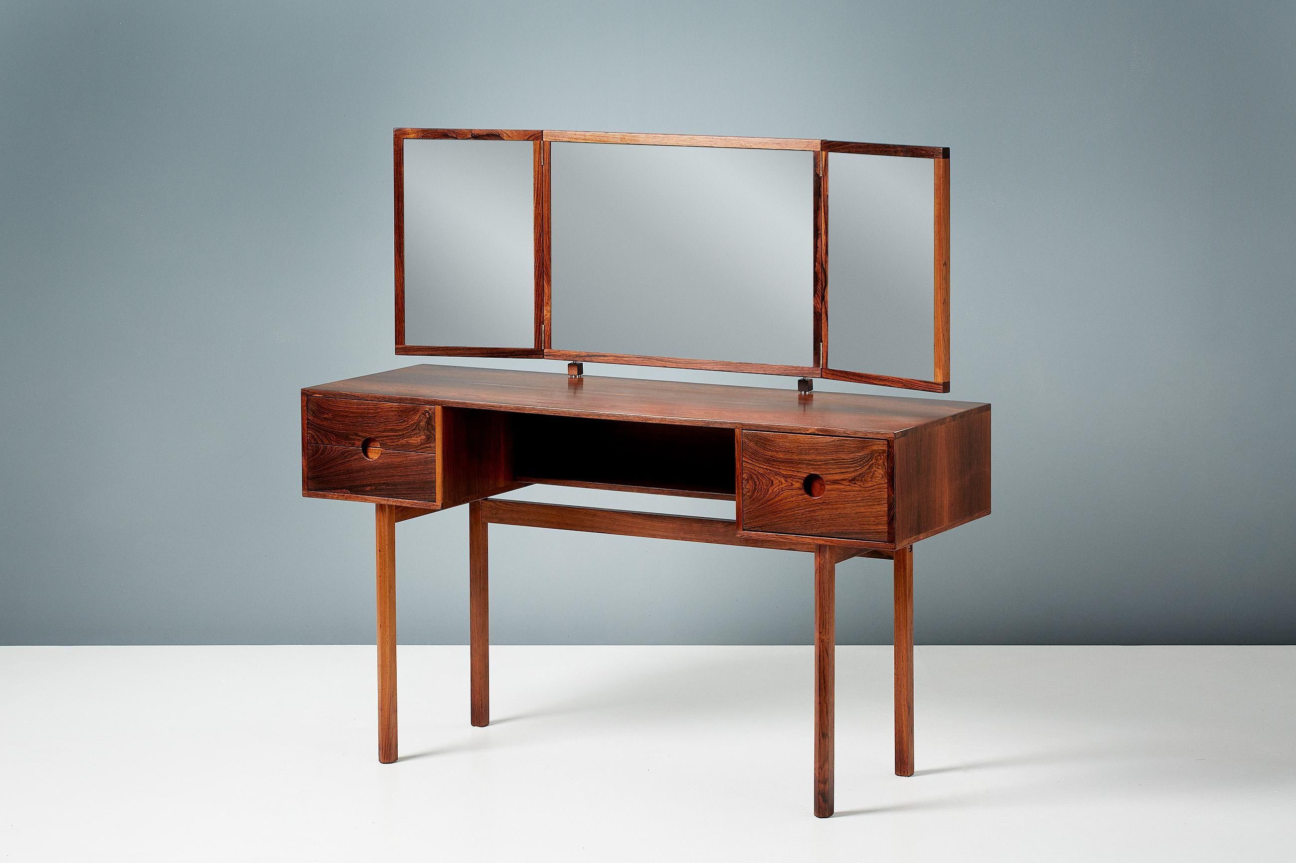 Kai Kristiansen

Rosewood Dressing table with folding 3-piece mirror. This dressing table was made from highly figured exotic rosewood by Aksel Kjersgaard in Denmark. Matching stool available by request. 

Dimensions:

Length 118cm; Depth