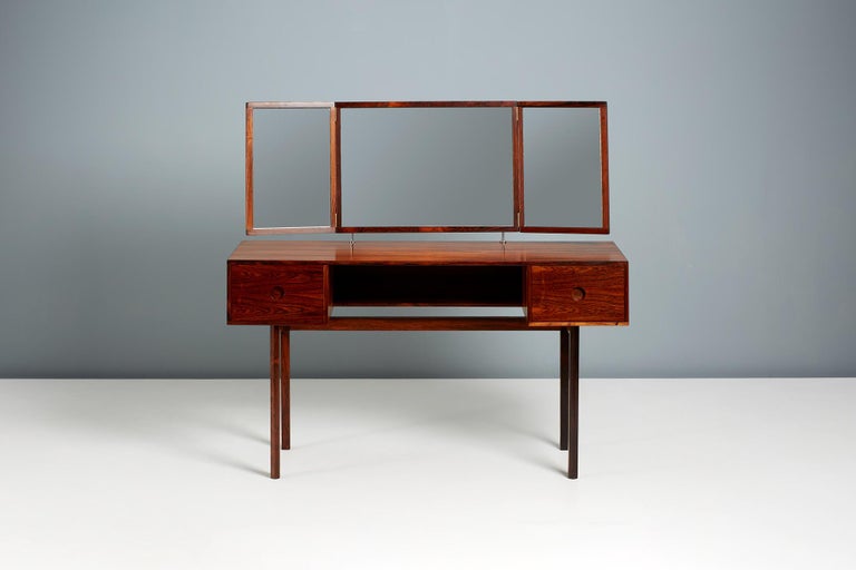 Kai Kristiansen

Model 40 Rosewood Dressing table with folding 3-piece mirror. This dressing table was made from highly figured exotic rosewood by Aksel Kjersgaard in Denmark. Matching stool available by request. 

Dimensions:

Length 118cm;
