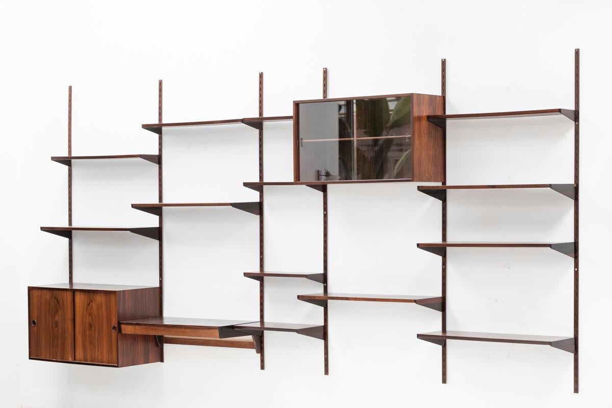 5-Piece wall unit designed by Kai Kristiansen and produced in Denmark in the 1960’s. A modular system which allows you to hang the configuration of shelves and cabinets as desired. The set features 6 wall supports, 6 shelves of 18 cm, 7 shelves of