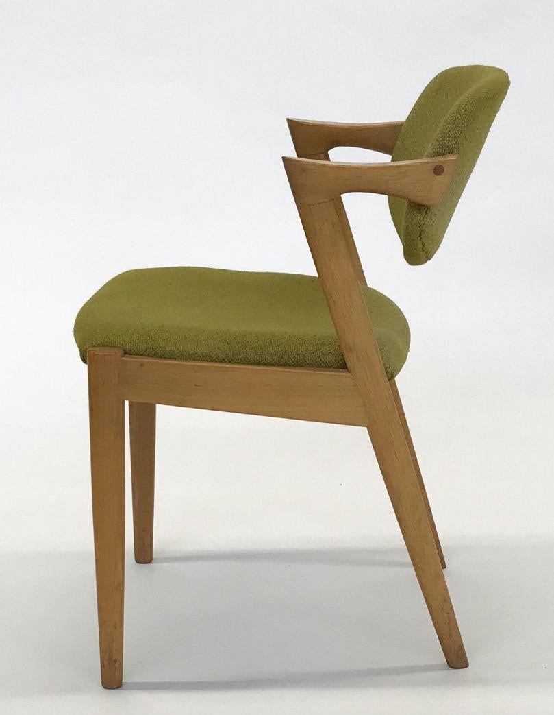 Set of eight (8) chairs!
Produced in Denmark in the 1960s. Classic elegant midcentury design by Kai Kristiansen (b. 1929).
Eight (8) chairs with solid oak frame, tilt backs and seats upholstered in green furnishing fabric. Designed 1956-1957.