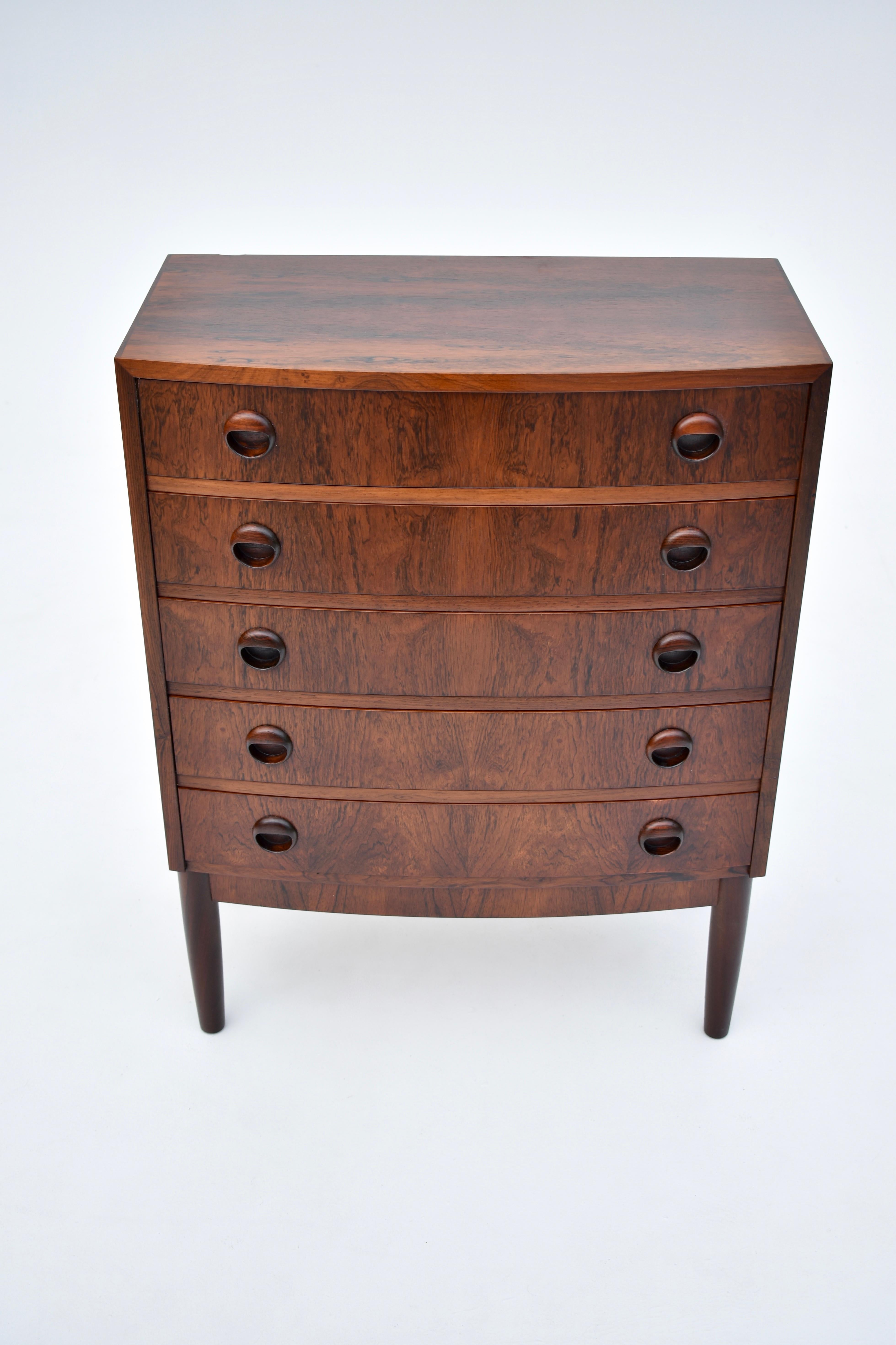 Wonderful little Brazilian rosewood chest of Drawers by Kai Kristiansen. An elegant bow fronted design with beautifully detailed drawer pulls. Very attractive and unusual whorled grain exhibited to the timber on this example.