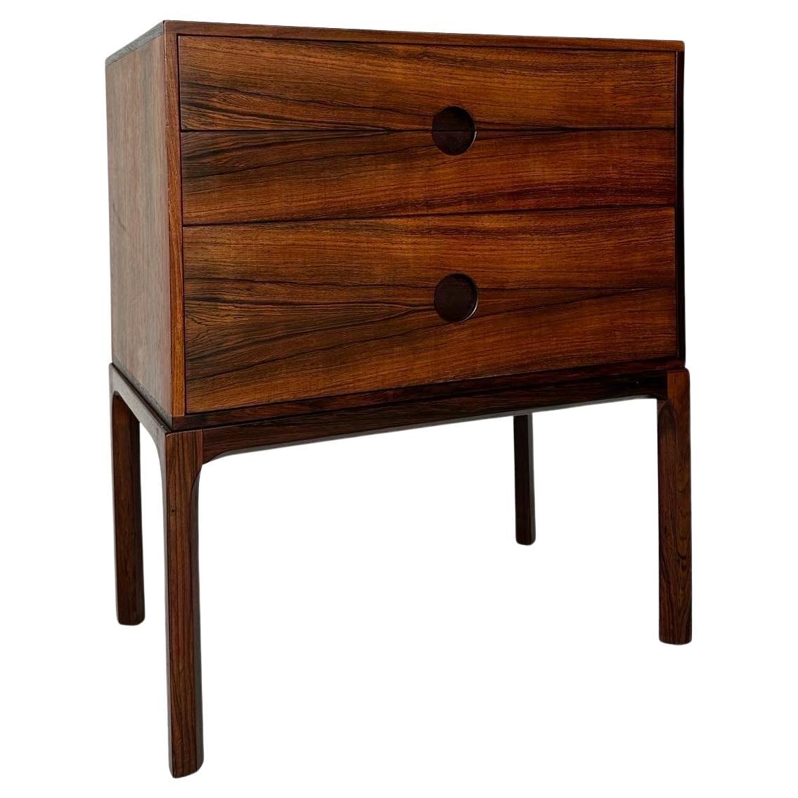 Beautiful Kai Kristiansen chest of drawers from the ‚Entré‘ series, No 386, produced by Aksel Kjersgaard in Denmark in the 1960s.

Made of rosewood with a distinct grain, three drawers with well crafted handles.

The right legs have been