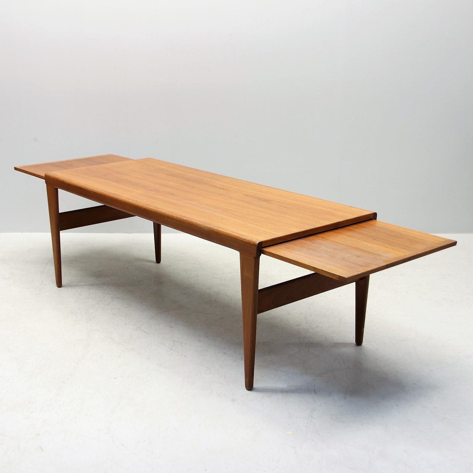 Sleek, sophisticated and somewhat surprising. This mid-1960s teak coffee table by famous Danish designer Kai Kristiansen is the epitome of midcentury style. Features two pull-out pieces that extend the surface area. Wear consistent with age and