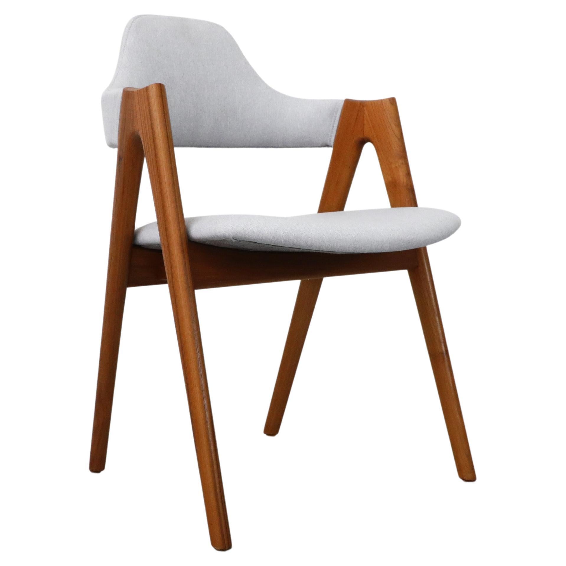 Single Kai Kristiansen Compass chair with light blue upholstery and solid oak frame. The Compass Dining Chair was designed in 1958 by Kai Kristiansen for SVA Møbler and manufactured in Denmark. In original condition with visible scuffs and chips,