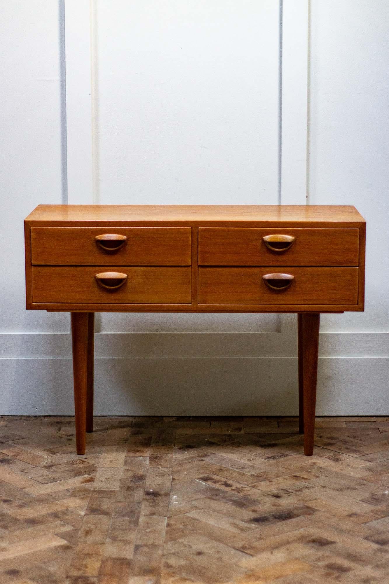 Teak chest of drawers or console designed by Kai Kristiansen in the early 1960s for Feldballes Mobelfrabrik in Denmark.

The unit is very well made with his own design of eyelid handles, Solid teak legs and dovetail joints on the