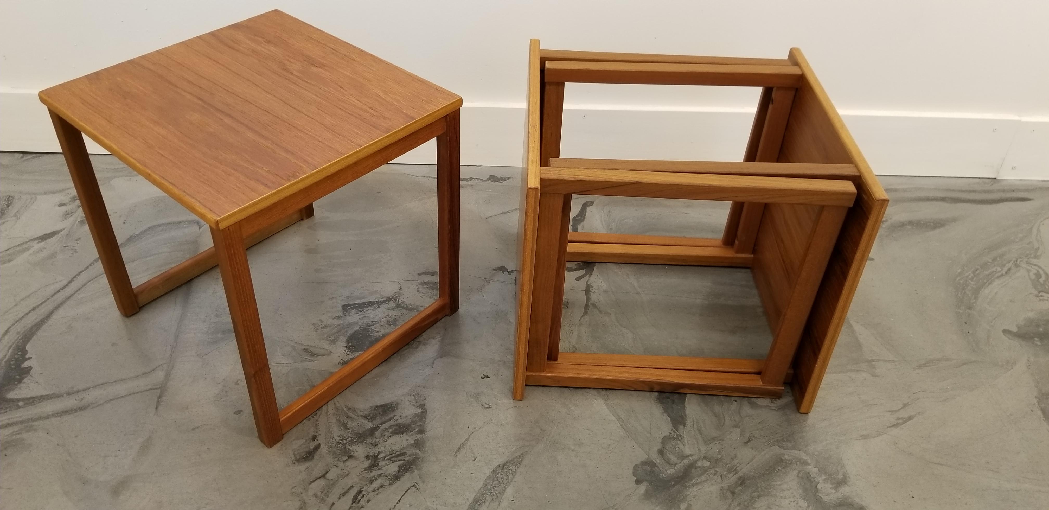 A versatile set of 3 Danish modern teak end tables nesting into a space-saving single cubical end table. Optional use as a set of 3 tables, a coffee table or a small coffee table and single end table set. Notice detailed book-matched wood grain to