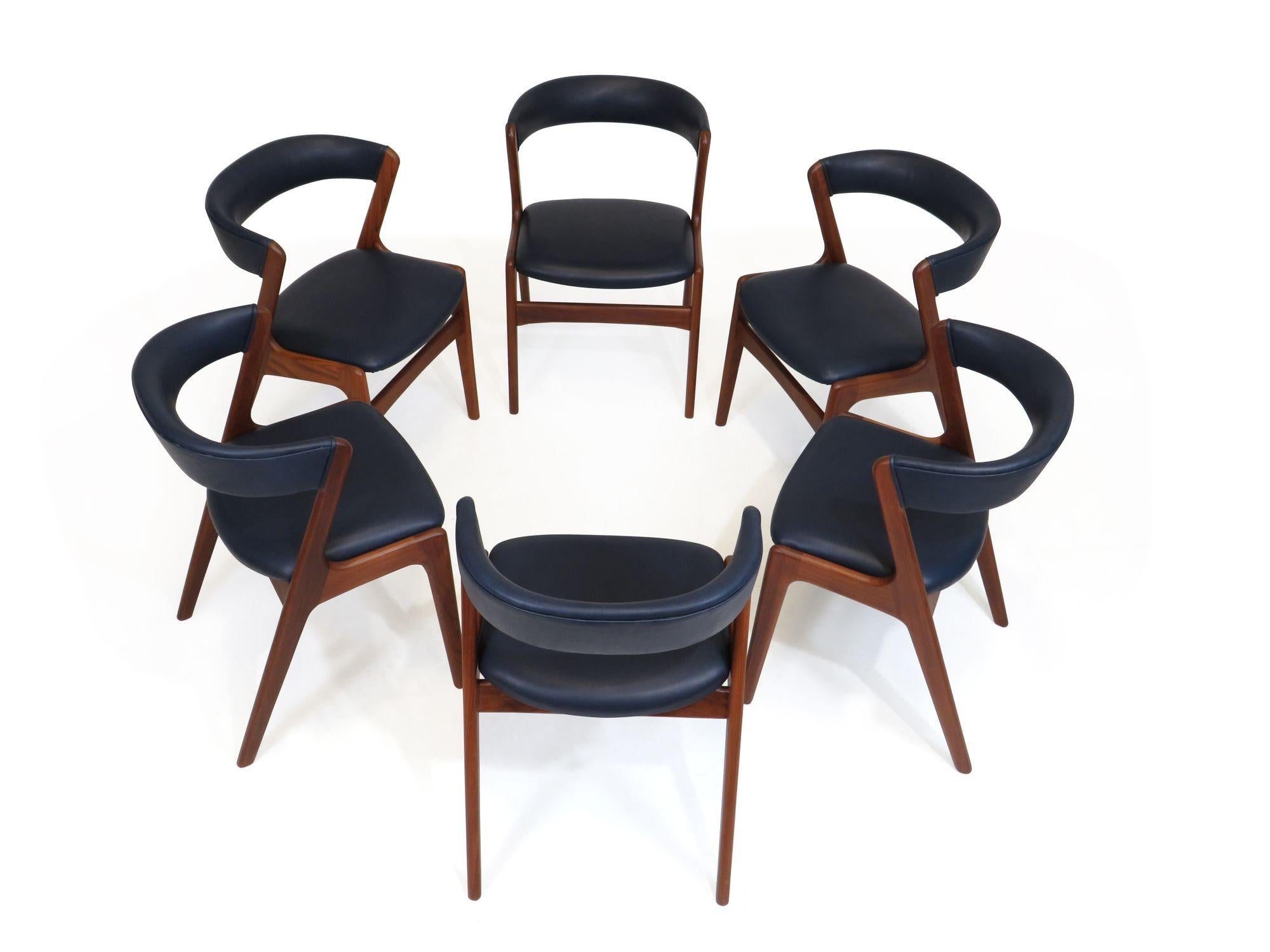 Set of six Mid-century Danish dining chairs designed by Kai Kristainsen, 1959, Denmark. Handcrafted of solid walnut with dramatic curved backs. Perfectly restored and upholstered in a full-aniline blue dyed leather with very soft feel over natural