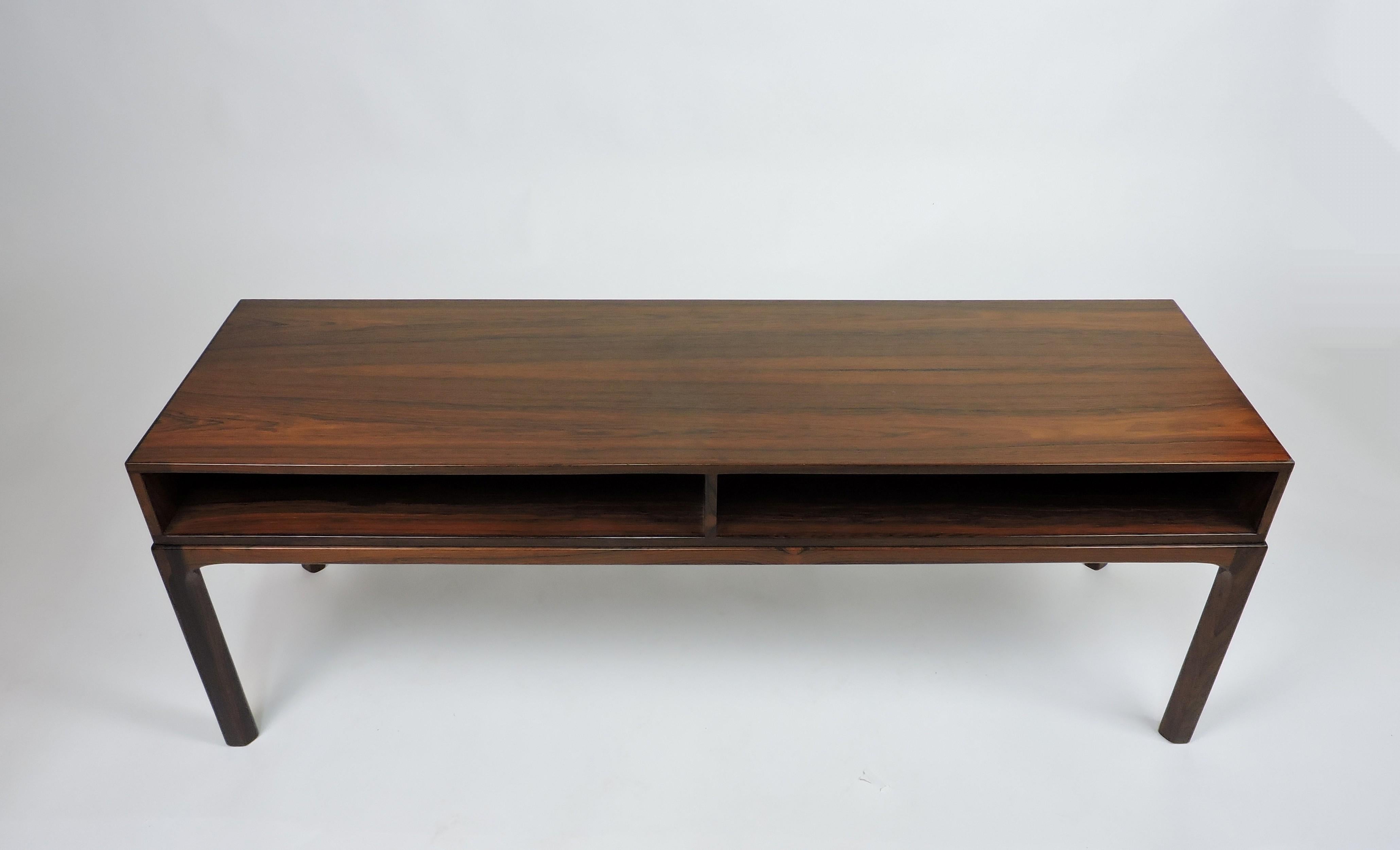 Handsome rosewood sideboard or table, model #393, designed by Kai Kristiansen and manufactured in Denmark by high-quality furniture maker, Askel Kjersgaard. This beautifully crafted open cabinet has two shelves for storage.
Marked with the Danish