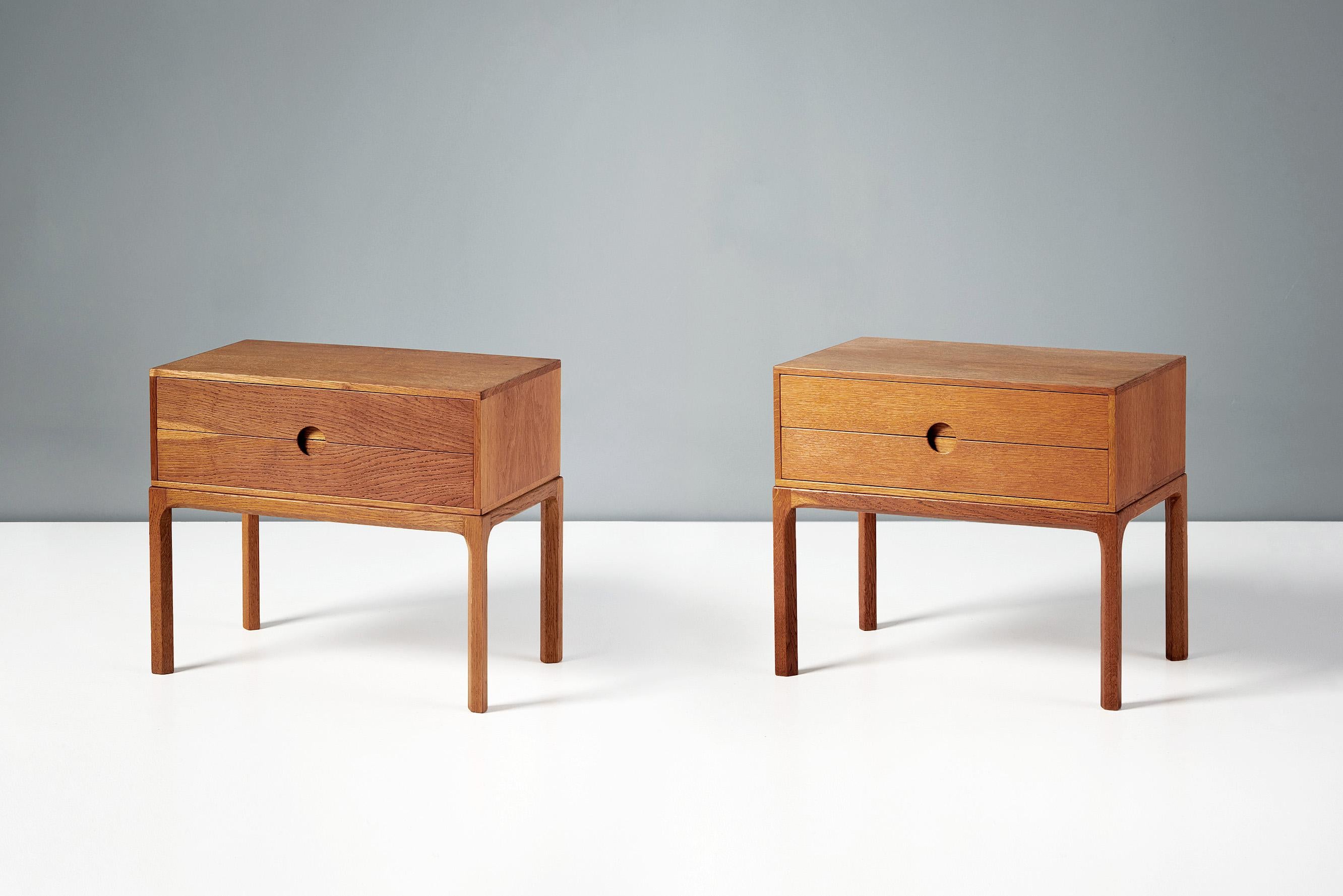 Kai Kristiansen - Bedside Cabinets, c1960s.

A pair of patinated oak bedside cabinets, produced by Aksel Kjersgaard in Odder, Denmark in the early 1960s. The design features Kristiansen’s trademark half-moon drawer pulls synonymous with this series.