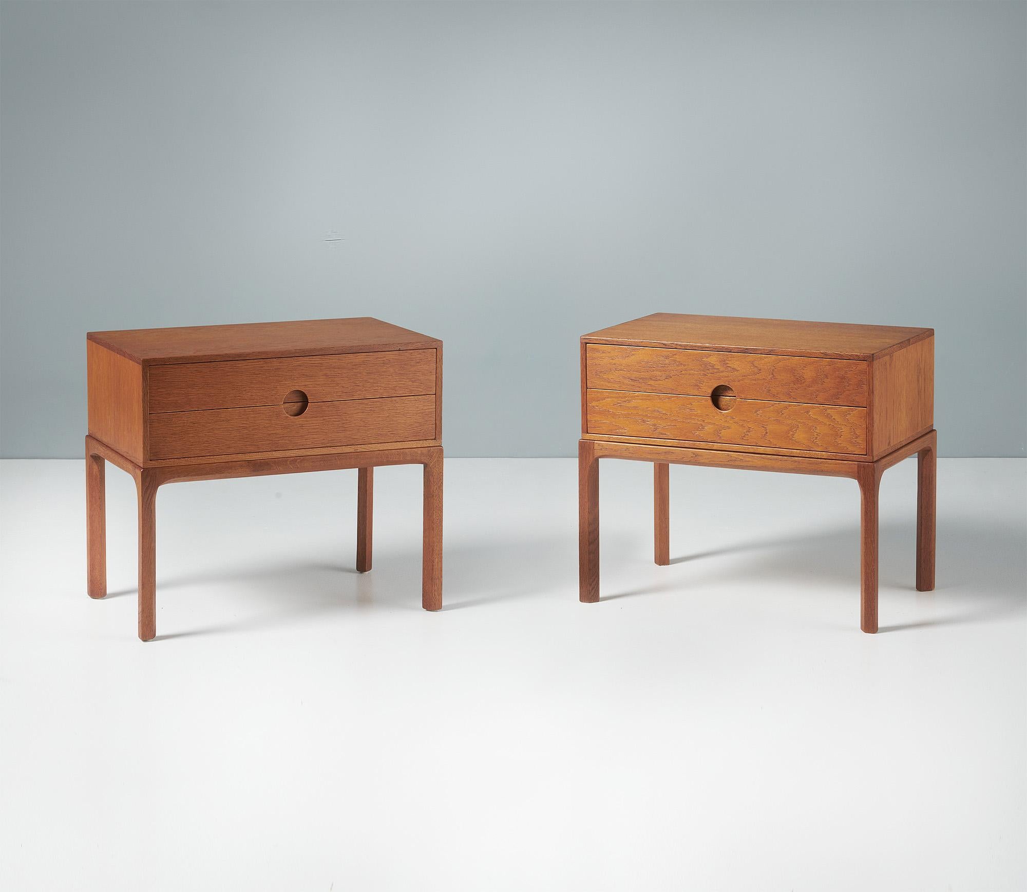 Kai Kristiansen - Bedside Cabinets, c1960s.

A pair of patinated oak bedside cabinets, produced by Aksel Kjersgaard in Odder, Denmark in the early 1960s. The design features Kristiansen’s trademark half-moon drawer pulls synonymous with this series.