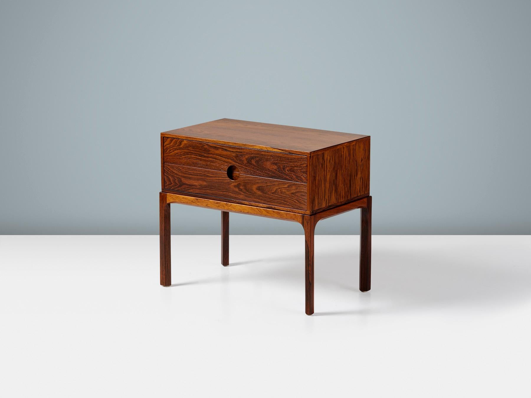 Kai Kristiansen - Model 384 Rosewood Nightstand, c1950s

An exquisite rosewood bedside cabinet, produced by cabinetmaker Aksel Kjaersgaard in Odder, Denmark circa 1950s. This design was part of Kai Kristiansen's iconic 'Entre' series of cabinets and