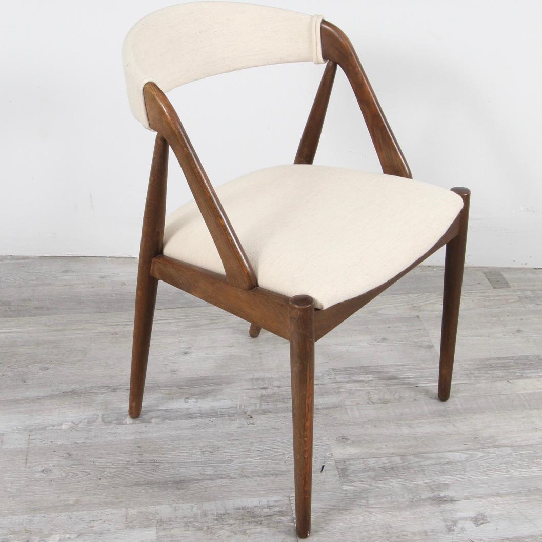 Clean Model 31 chair in walnut with a white wool upholstery.
About the designer: Kai Kristiansen was born in 1929. He apprenticed in cabinetmaking before he in 1948 enrolled in the prestigious Royal Danish Academy of Fine Arts in Copenhagen under