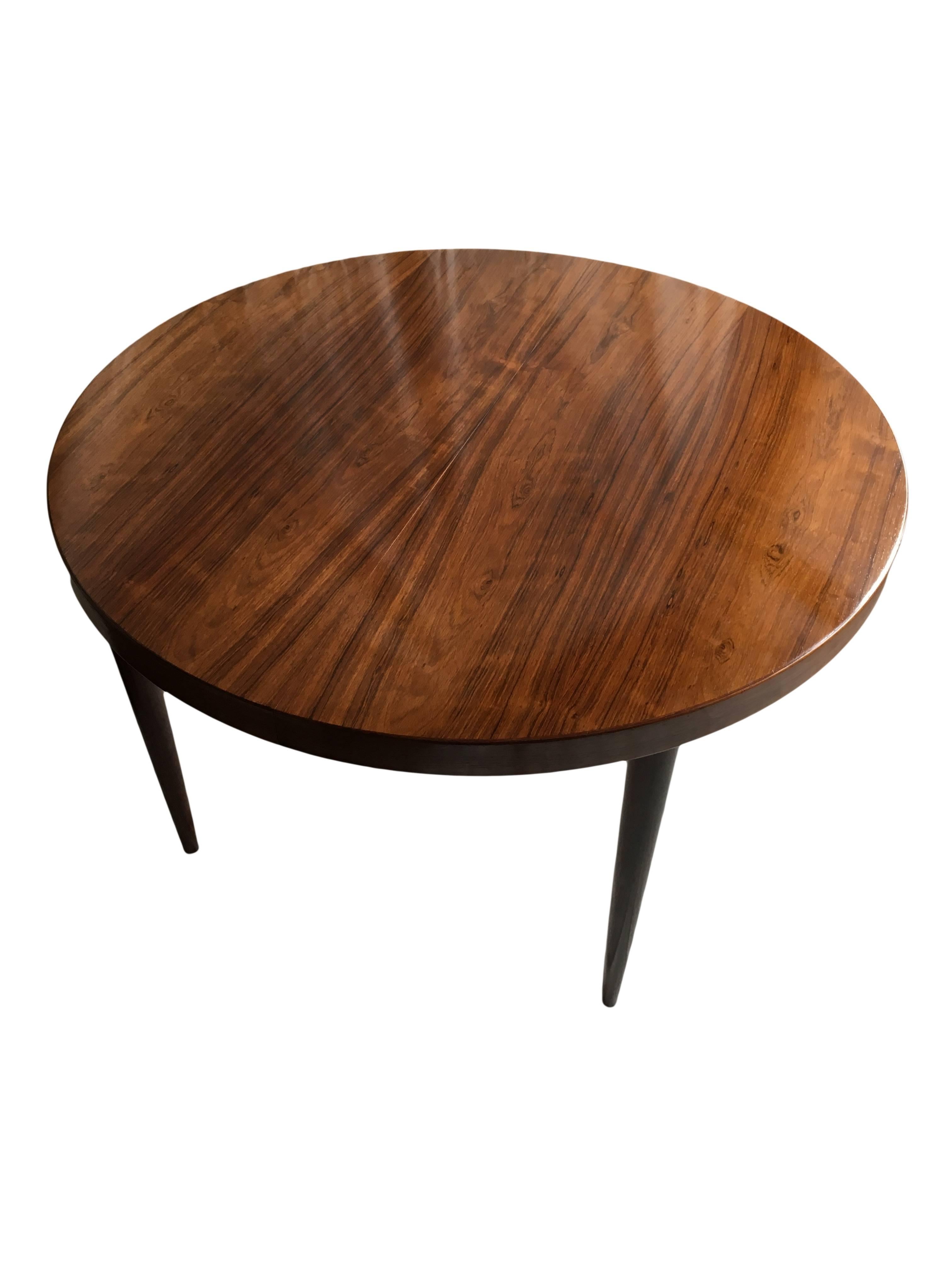 The classic Kai Kristiansen designed circular dining table. Ultra modernist in design. Extending with one drop-in leaf of 55cm. Danish production circa 1960. Lovely grain figuring and coloring.
Superb condition with refinished surface. We also have