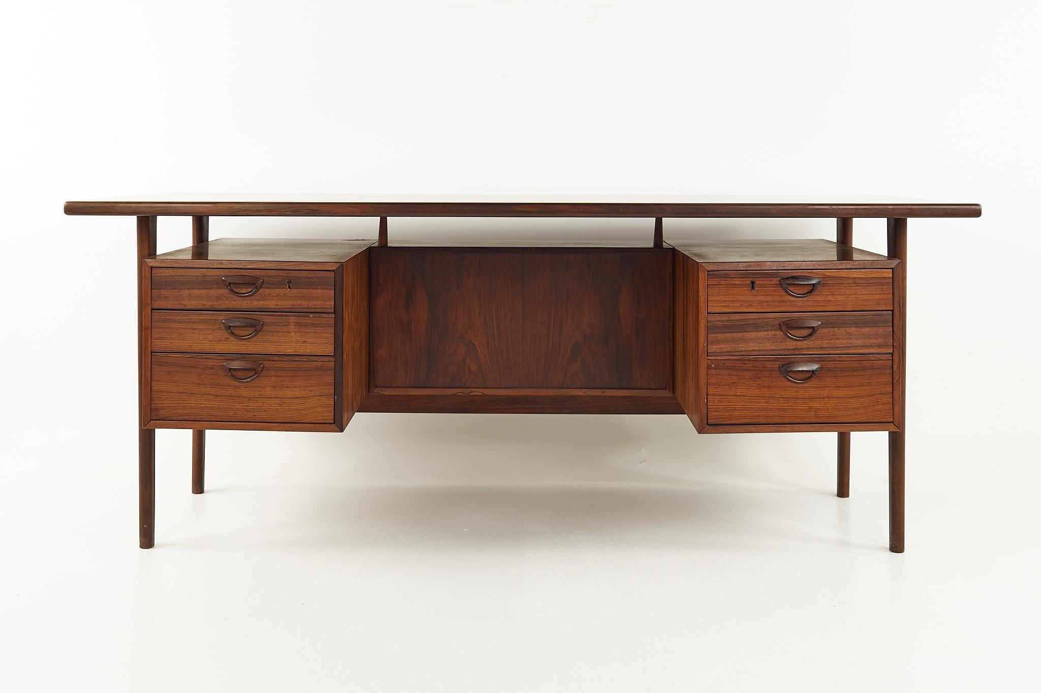 Kai Kristiansen FM 60 Mid Century Rosewood Executive desk

This desk measures: 70.75 wide x 33.25 deep x 28.5 inches high, with a chair clearance of 27.5 inches

All pieces of furniture can be had in what we call restored vintage condition. That