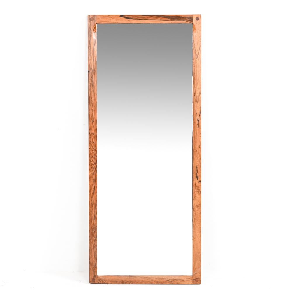 Simple and elegant, this Model No. 165 wall mirror features a solid rosewood frame softened by an interior notched edge. Designed by Kai Kristiansen for Aksel Kjersgaard and Odder Furniture, with stamps on the back indicating maker and model number.