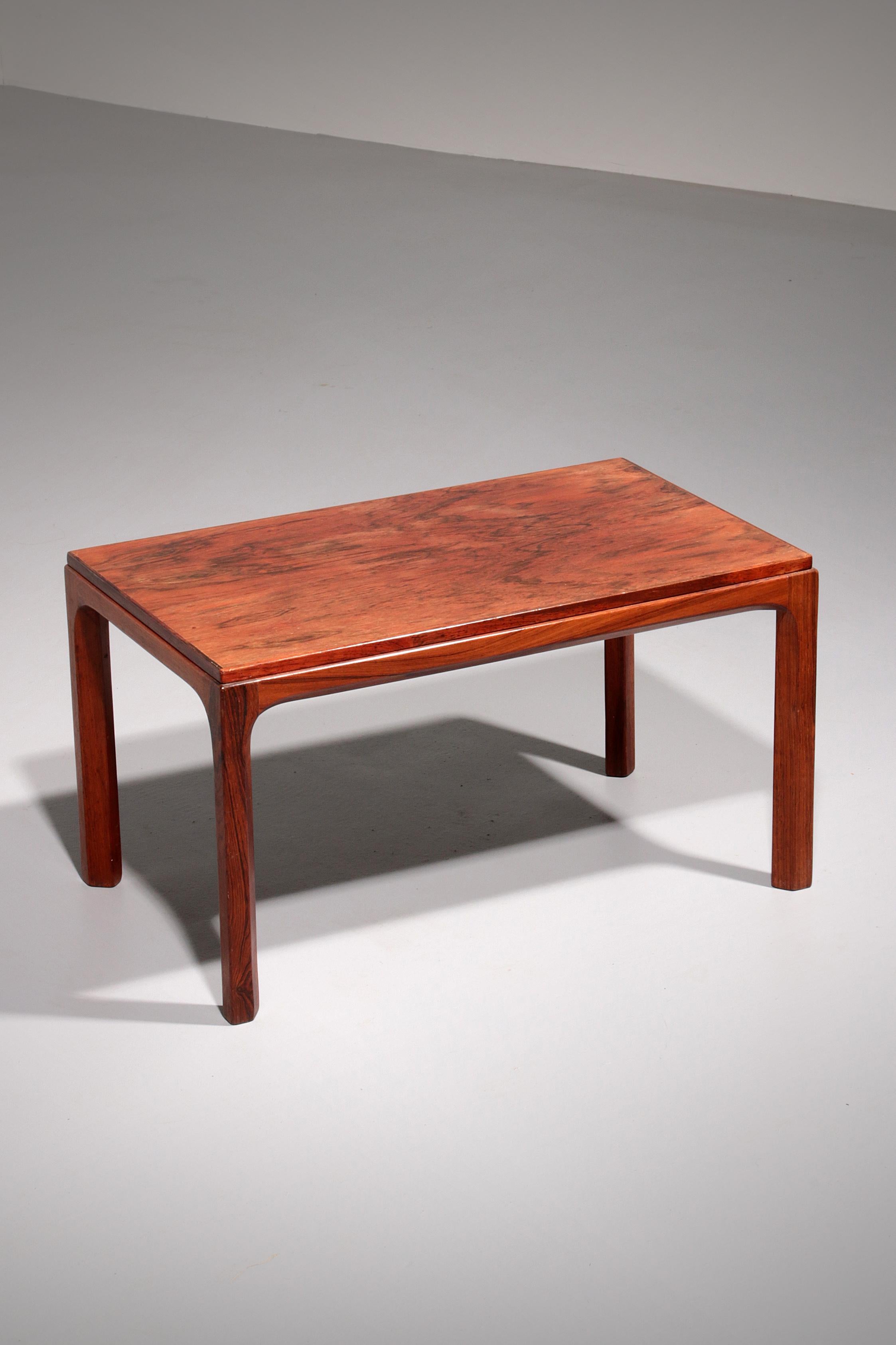 This side table is designed by Kai Kristiansen and manufactured by Aksel Kjersgaard in Denmark in the 1960s. The typical design is refined in all details. There are beautiful drawings in the wood. There is a logo by the manufacturer. This side table