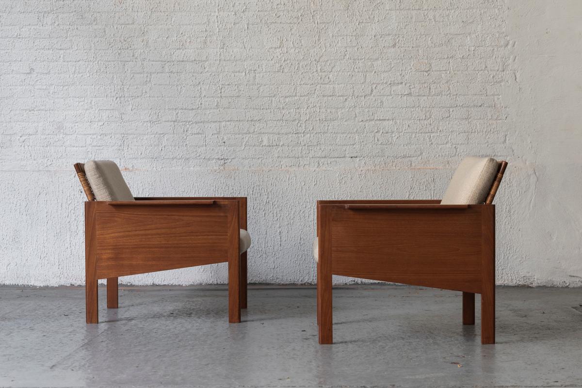 Rare pair of easy chairs ‘Model 150’, designed by Kai Kristiansen and produced by Christian Jensen Møbelsnedkeri in Denmark in the 1960’s. These lounge chairs are made of a wooden frame with a woven rattan backrest. Original cushions with an