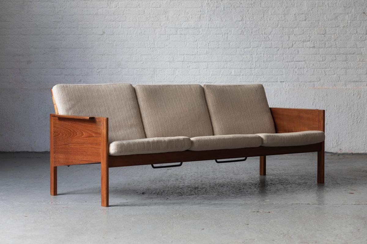 Rare 3-seater sofa, designed by Kai Kristiansen and produced by Christian Jensen Møbelsnedkeri in Denmark in the 1960’s. This sofa features a wooden frame with woven rattan backrests. Original cushions with an upholstery in a beautiful beige-white