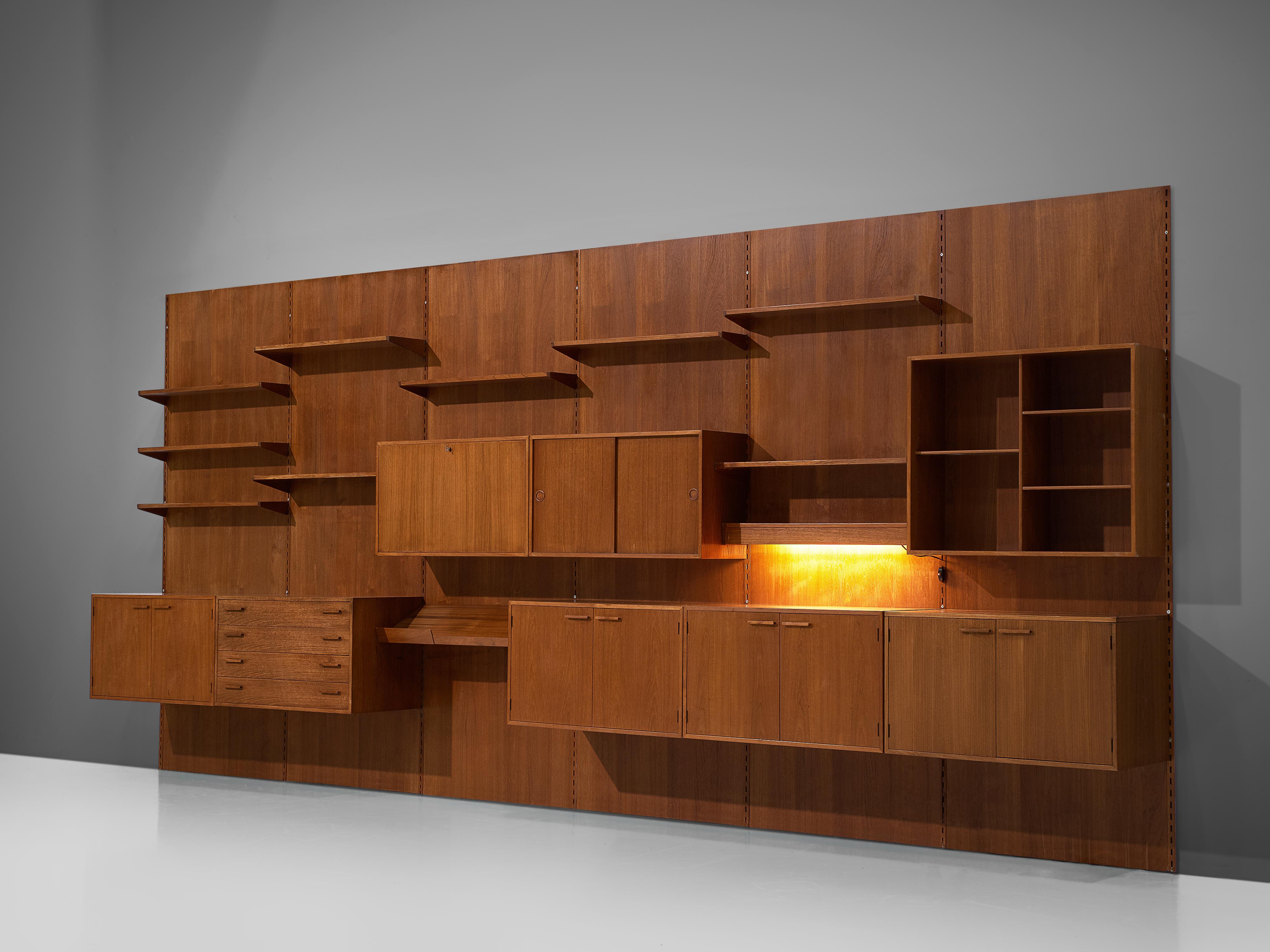 Kai Kristiansen for Feldballes Møbelfabrik, wall-mounted shelving unit, teak, Denmark, circa 1955.

This large 5.2mt/17ft wall unit was designed by Danish designer Kai Kristiansen. The cabinet consists of six wall-mounted compartments that allow