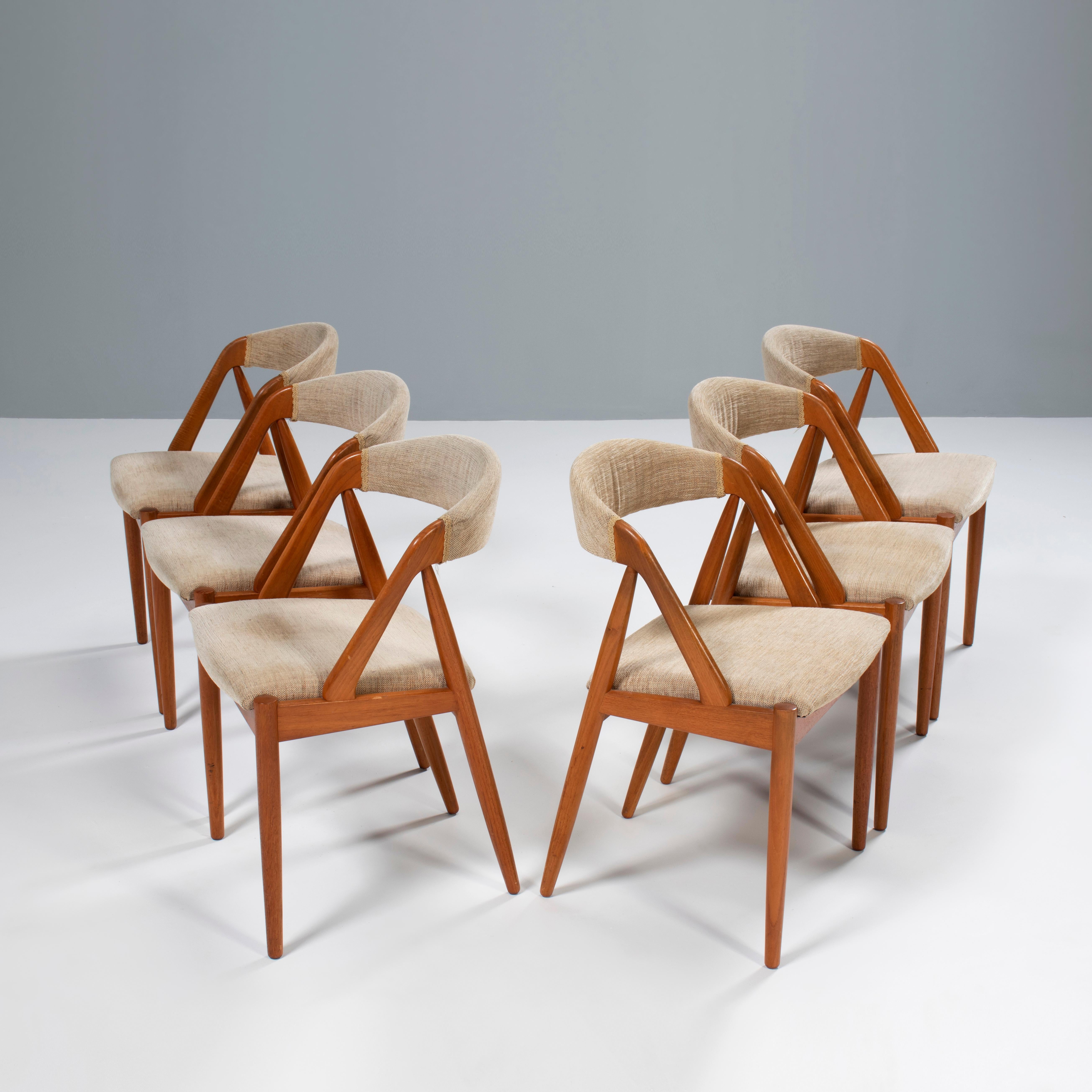 Designed by Kai Kristiansen for Schou Andersen the Model 31 dining chair is a fantastic example of classic Danish Mid-Century design.

Constructed from teak, the chairs have a classic silhouette combining a curved backrest with angled legs and arm