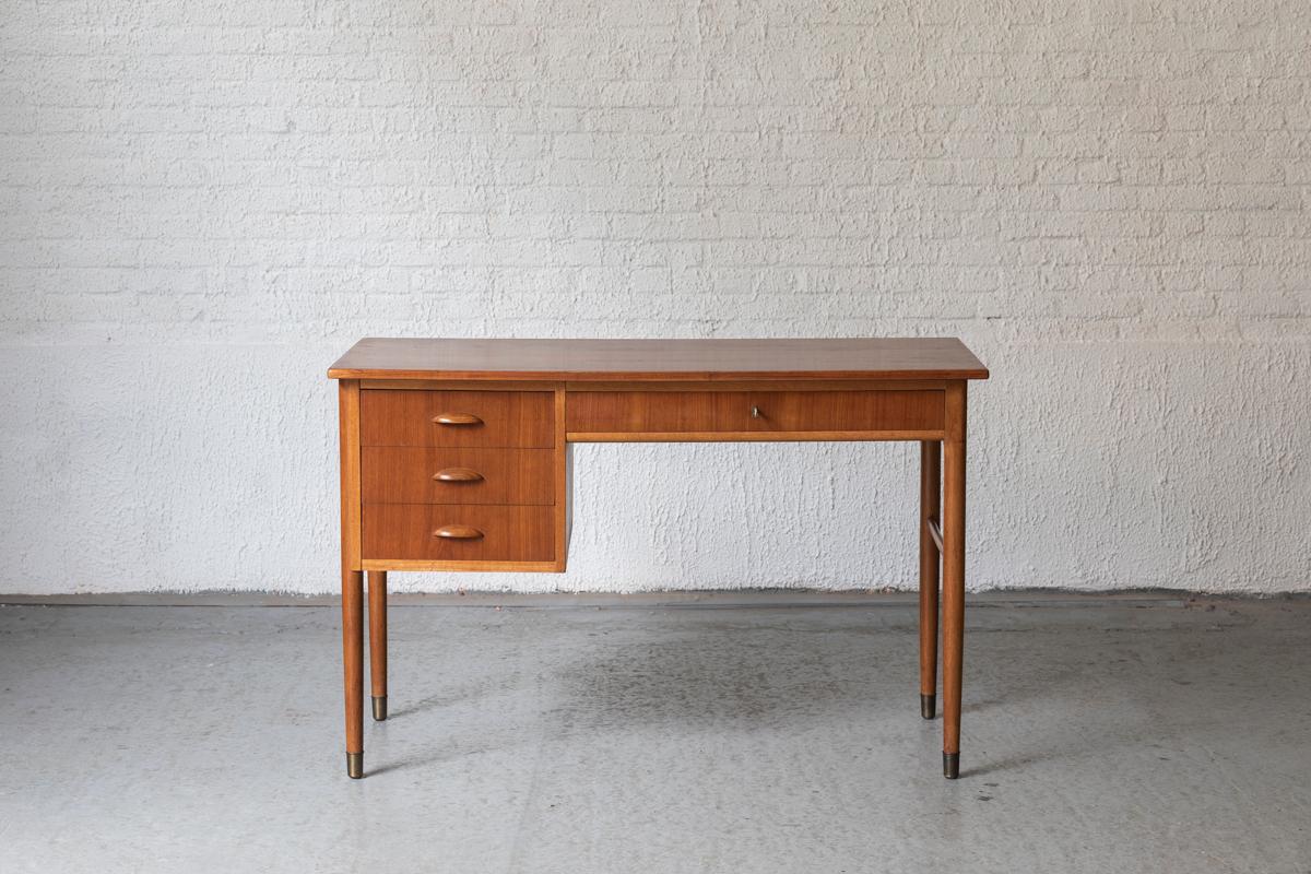 Writing desk, designed by Kai Kristiansen and produced in Denmark in the 1960’s. The design features 3 compact drawers and 1 larger drawer. There’s a working lock to secure this top drawer with the original key. Finished in the back, making it