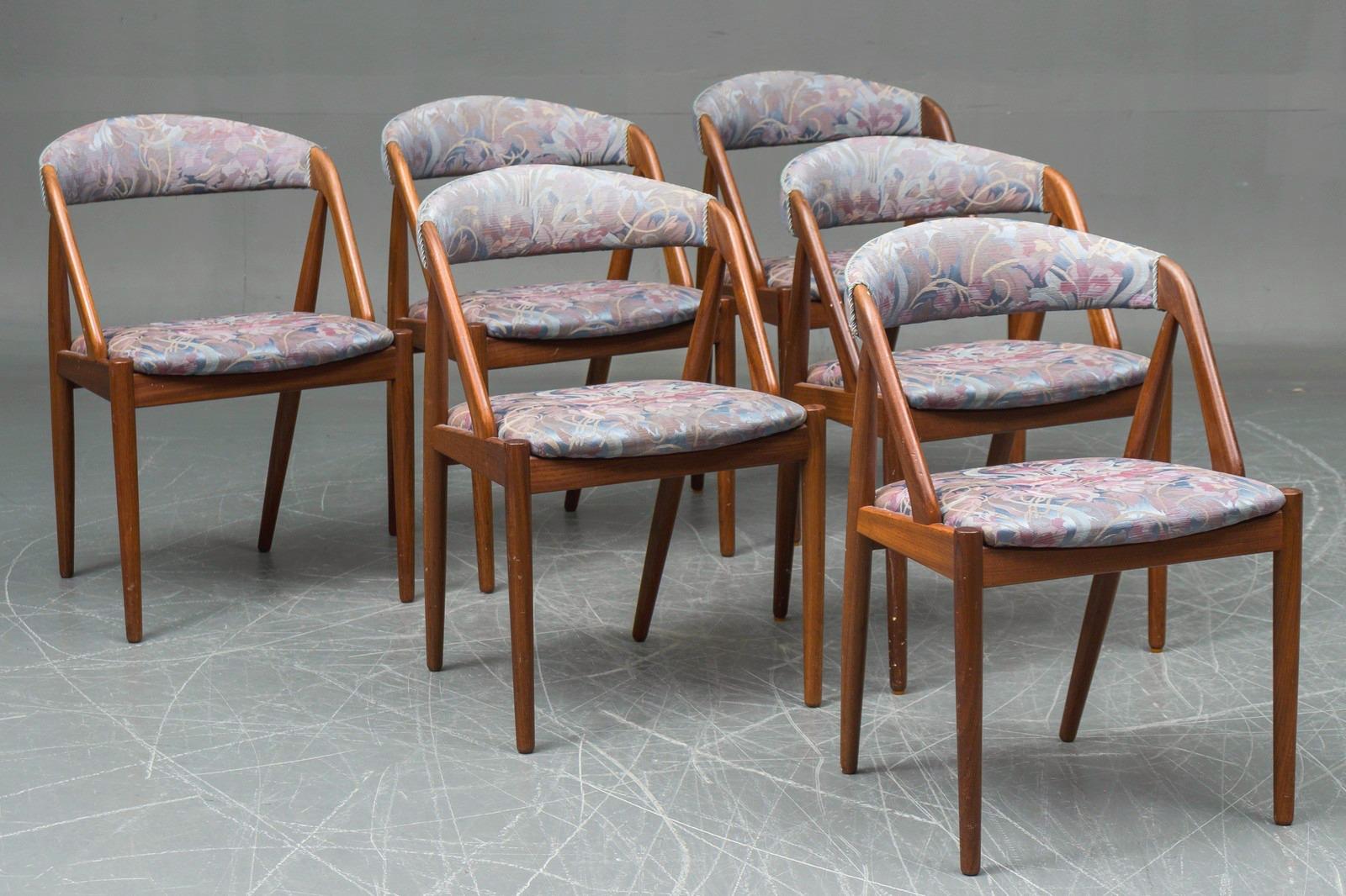 This set of three dining room chairs was designed by Kai Kristiansen in 1956 and manufactured by Schou Andersen in the 1960s in Denmark. The chairs are made from teak and upholstered in green colored wool. Beautiful frames with very nice color and