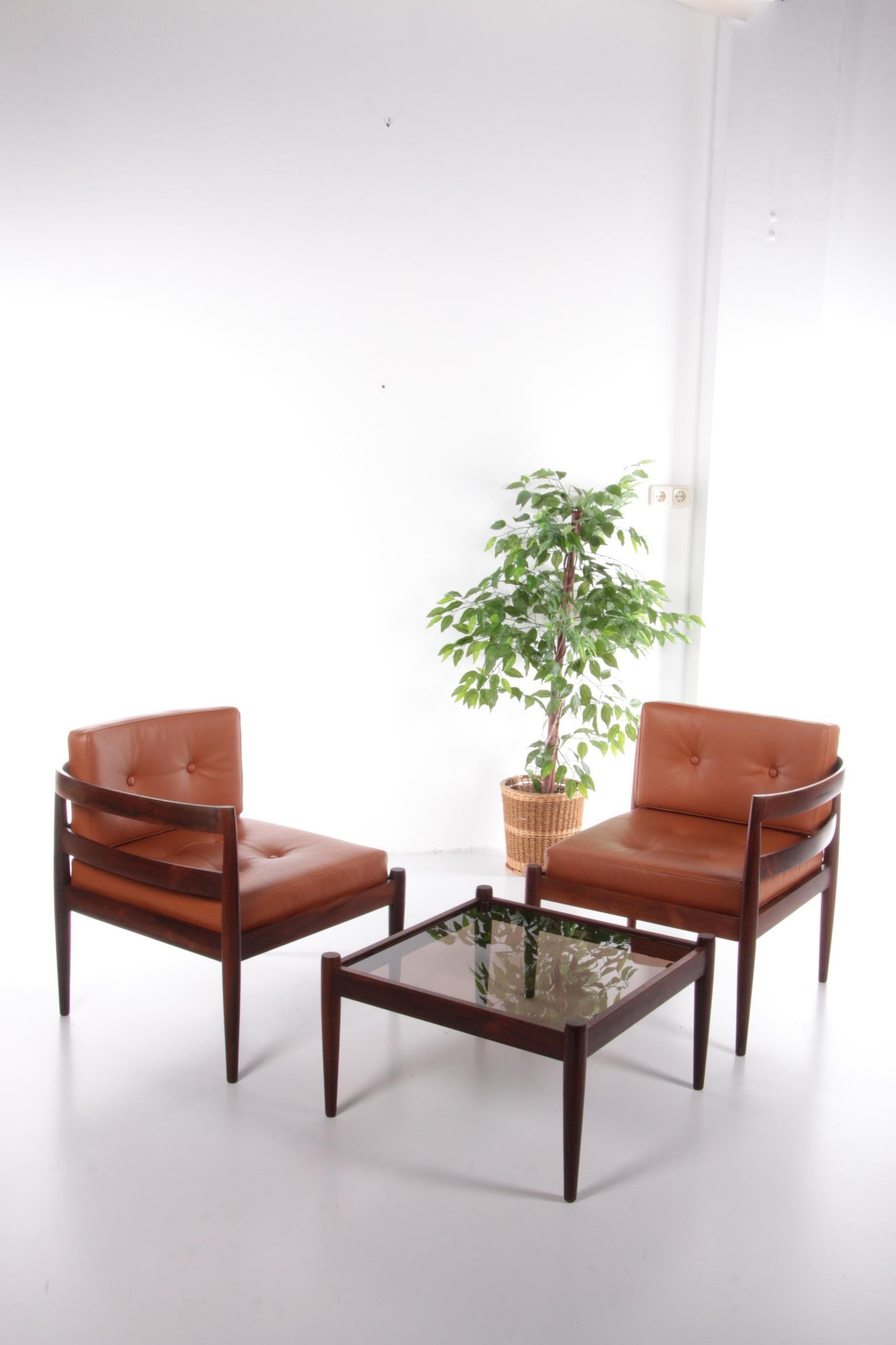 Kai Kristiansen Lounge set Model Universe by Magnus Olesen, 1960 Denmark

An iconic three piece modular unit of Kai Kristiansen's model universe chairs in beautiful Brazilian darkwood and original cognac color leather upholstery.

Designed in 1966