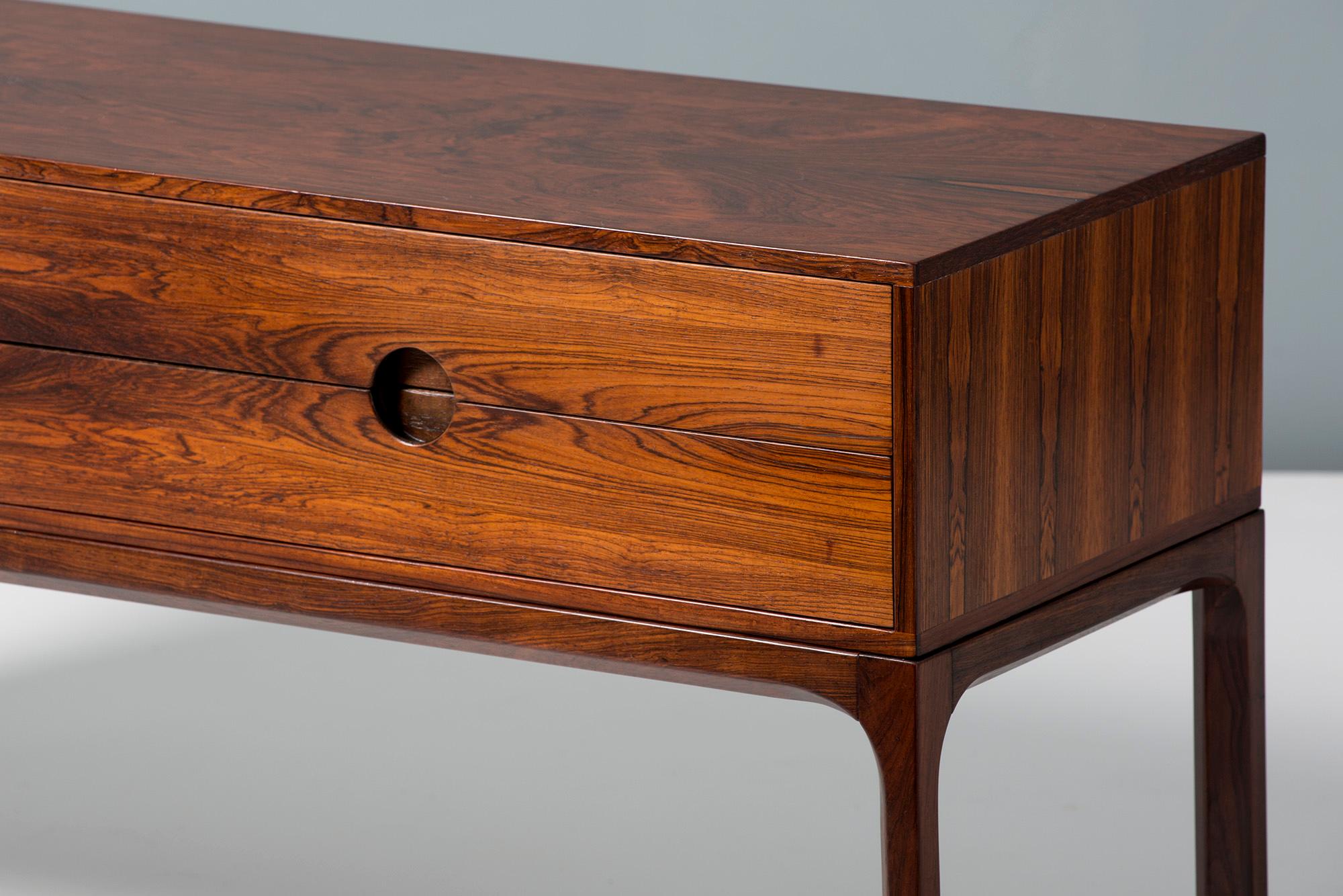 Kai Kristiansen
Low chest, circa 1960.

Low, 4-drawer chest made from solid and veneered Brazilian rosewood, produced by cabinetmaker Aksel Kjaersgaard in Odder, Denmark, circa 1960. 

The chest has 2 sets of drawers with Kristiansen's