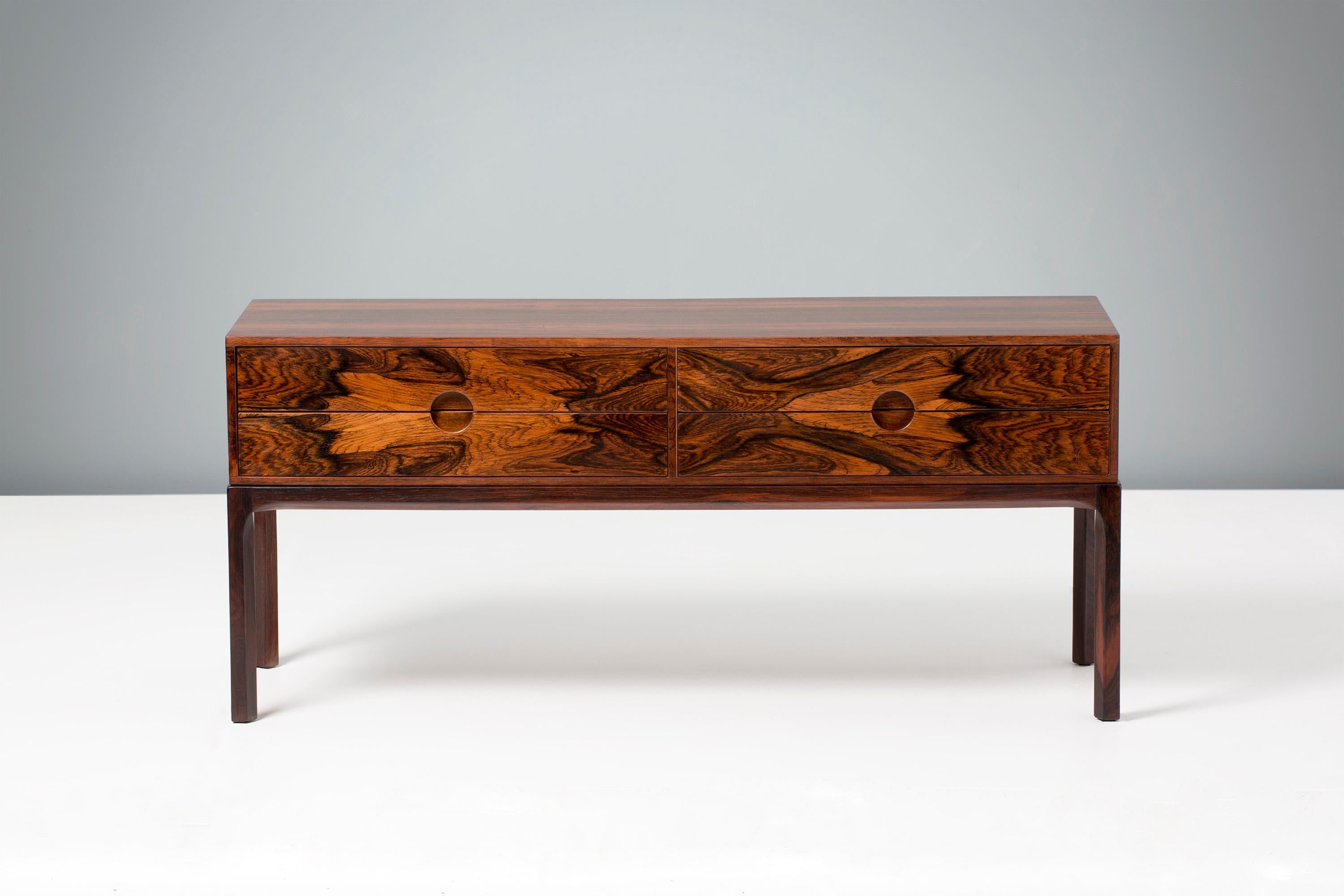Kai Kristiansen
Low chest, circa 1960.

Low, 4-drawer chest made from solid and veneered Brazilian rosewood, produced by cabinetmaker Aksel Kjaersgaard in Odder, Denmark, circa 1960.

The chest has 2 sets of drawers with Kristiansen's trademark