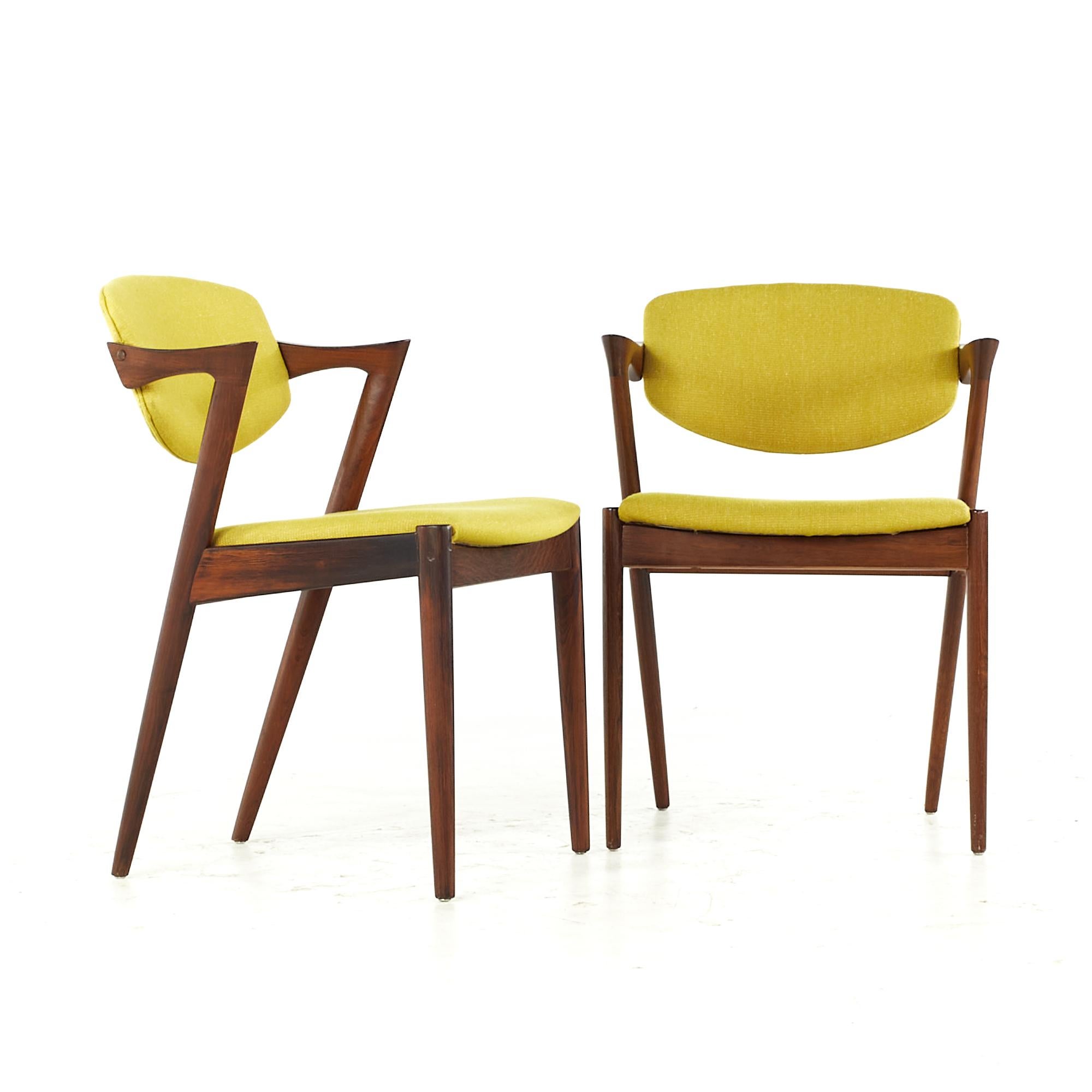 Kai Kristiansen midcentury Rosewood Z dining chairs - pair.

This chair measures: 19.75 wide x 19.25 deep x 29 high, with a seat height of 17.5 and arm height/chair clearance 26.5 inches.

All pieces of furniture can be had in what we call