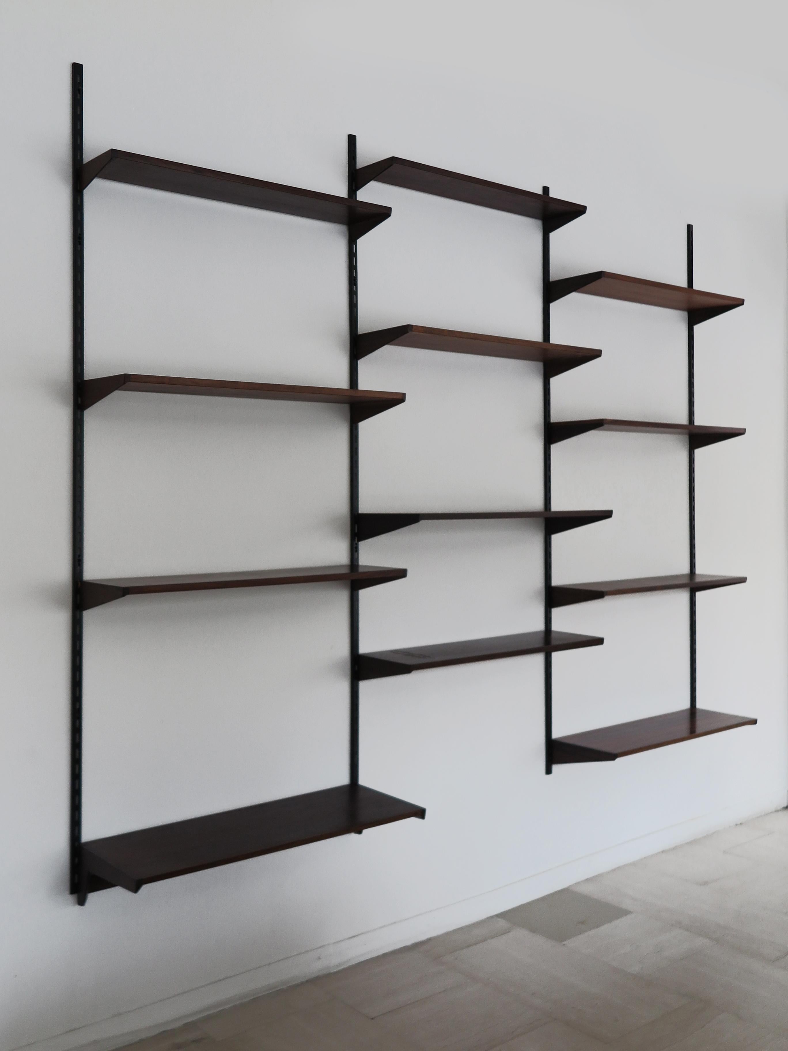 Midcentury modern design scandinavian dark wood shelving system designed by Kai Kristiansen for FM Mobler consisting of 12 shelves with different depths, manufacturer’s adhesive label behind some shelves, production Denmark 1960s
Original