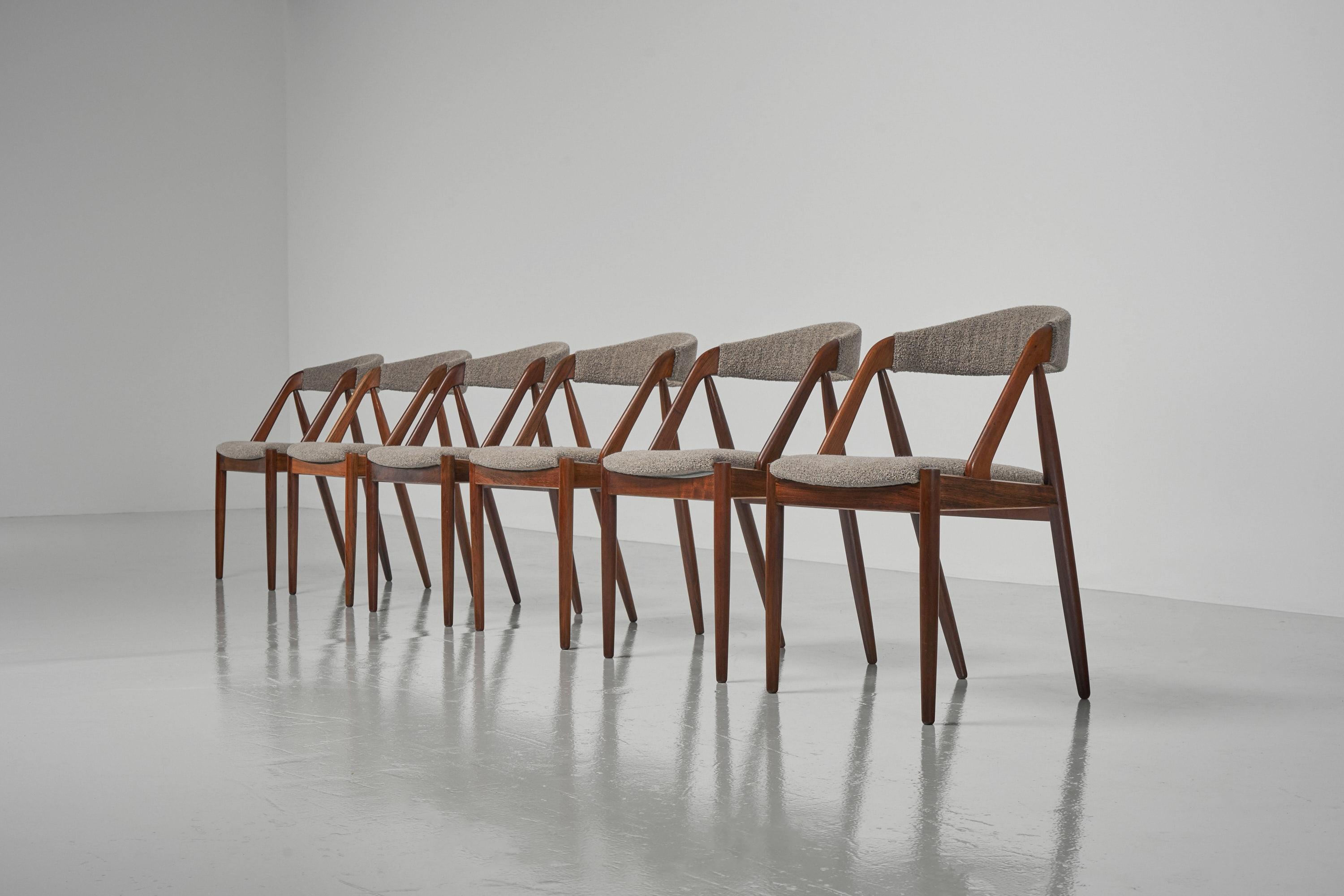 Elegant set of 6 'model 31' dining chairs designed by Kai Kristiansen and manufactured by Schou Andersen, Denmark 1956. These typical Danish Modern dining chairs have solid rosewood frames which have the appearance to disappear in the upholstery.