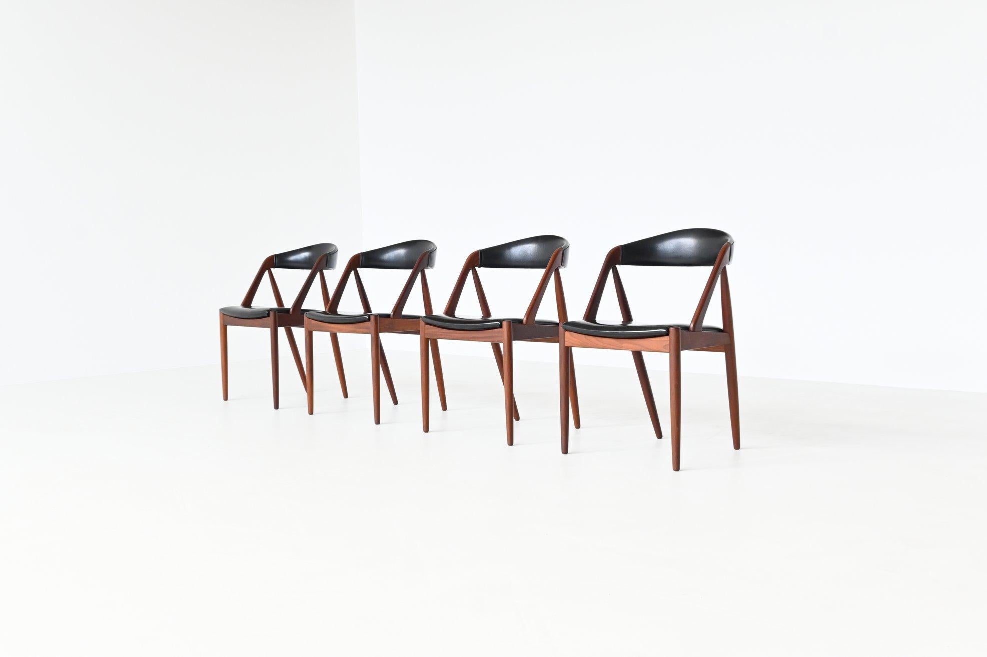 Beautiful shaped and well-crafted set of four dining chairs model 31 designed by Kai Kristiansen and manufactured by Schou Andersen Møbelfabrik, Denmark 1960. The frames are made of solid teak wood with curved backrest, crooked angles and straight