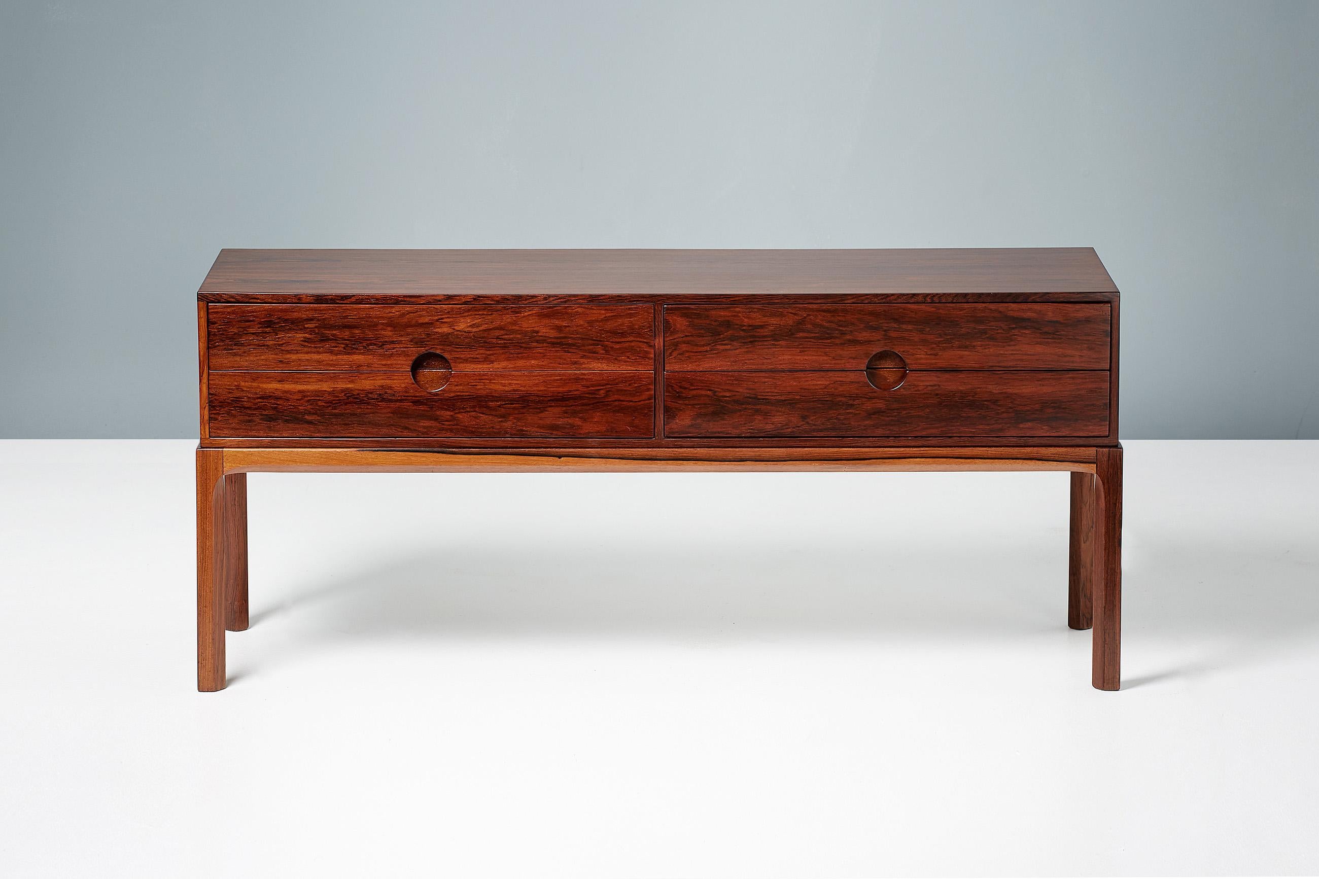 Kai Kristiansen

Model 384 chest, c1960

Low, 4-drawer chest made from highly figured rosewood, produced by Aksel Kjersgaard in Odder, Denmark, c1960. Features Kristiansen’s trademark circular drawer pulls. 

Measures: H 52 cm 
W 118 cm 
D
