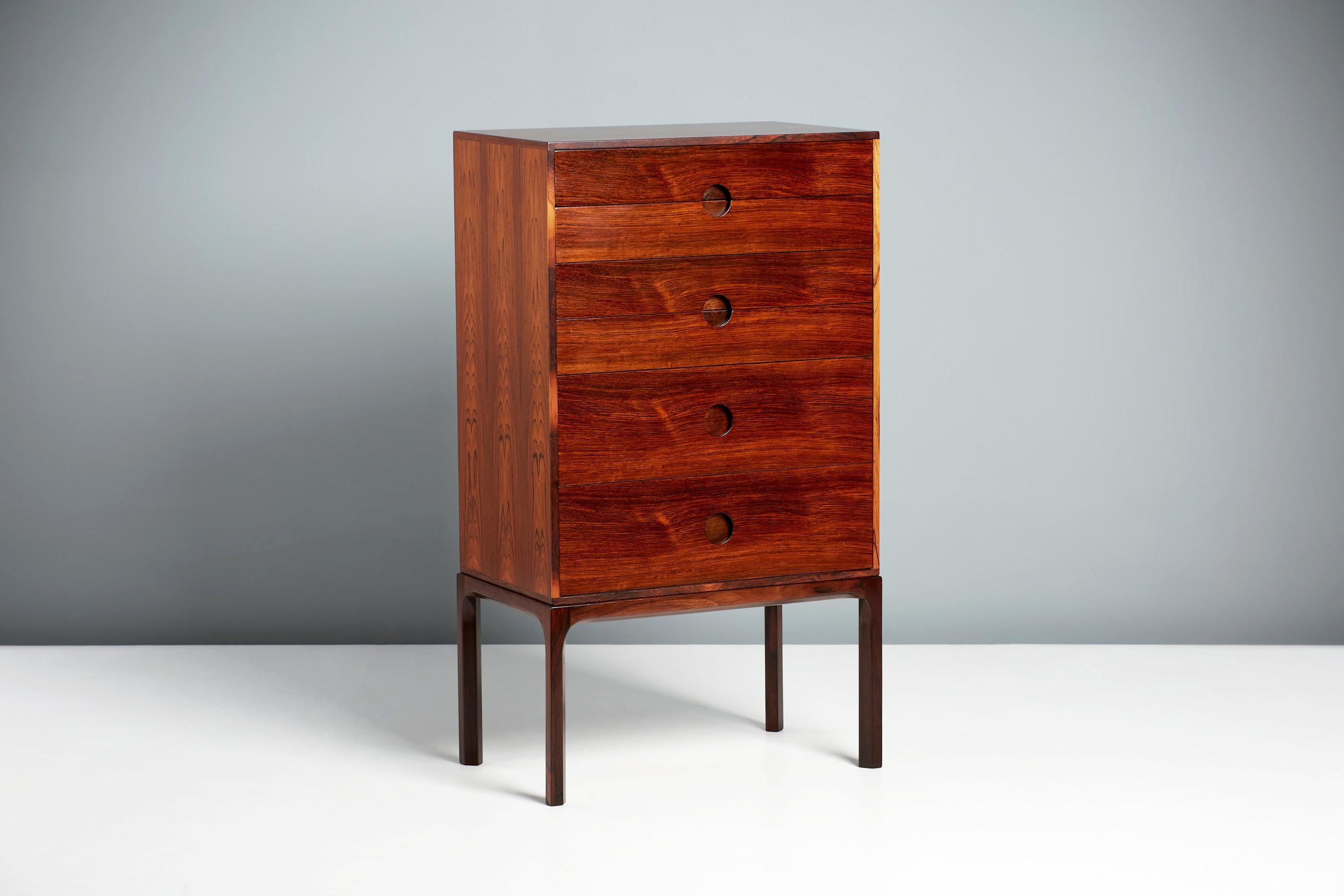 Kai Kristiansen Model 385 Chest of Drawers, circa 1960

Rosewood tallboy chest, produced by Aksel Kjersgaard in Odder, Denmark. Solid rosewood frame with veneered cabinet and half-moon drawer pulls. Refinished in Danish oil. Rarely seen model from