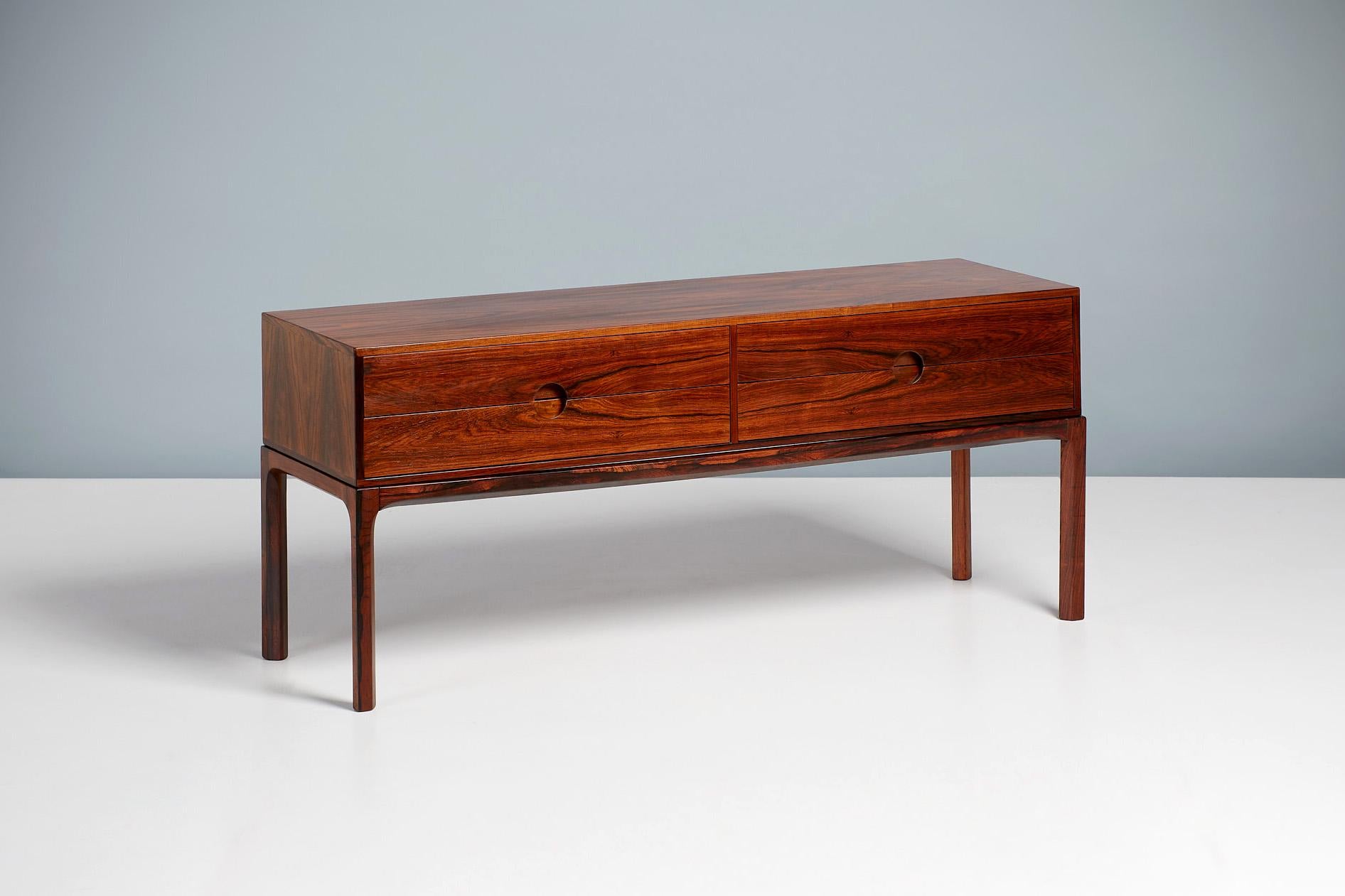 Kai Kristiansen

Model 394 Low Chest, c1960.

A low, 4-drawer chest made from highly figured rosewood, produced by Aksel Kjersgaard in Odder, Denmark, c1960. Features Kristiansen’s trademark circular half-moon drawer pulls. Exceptional quality