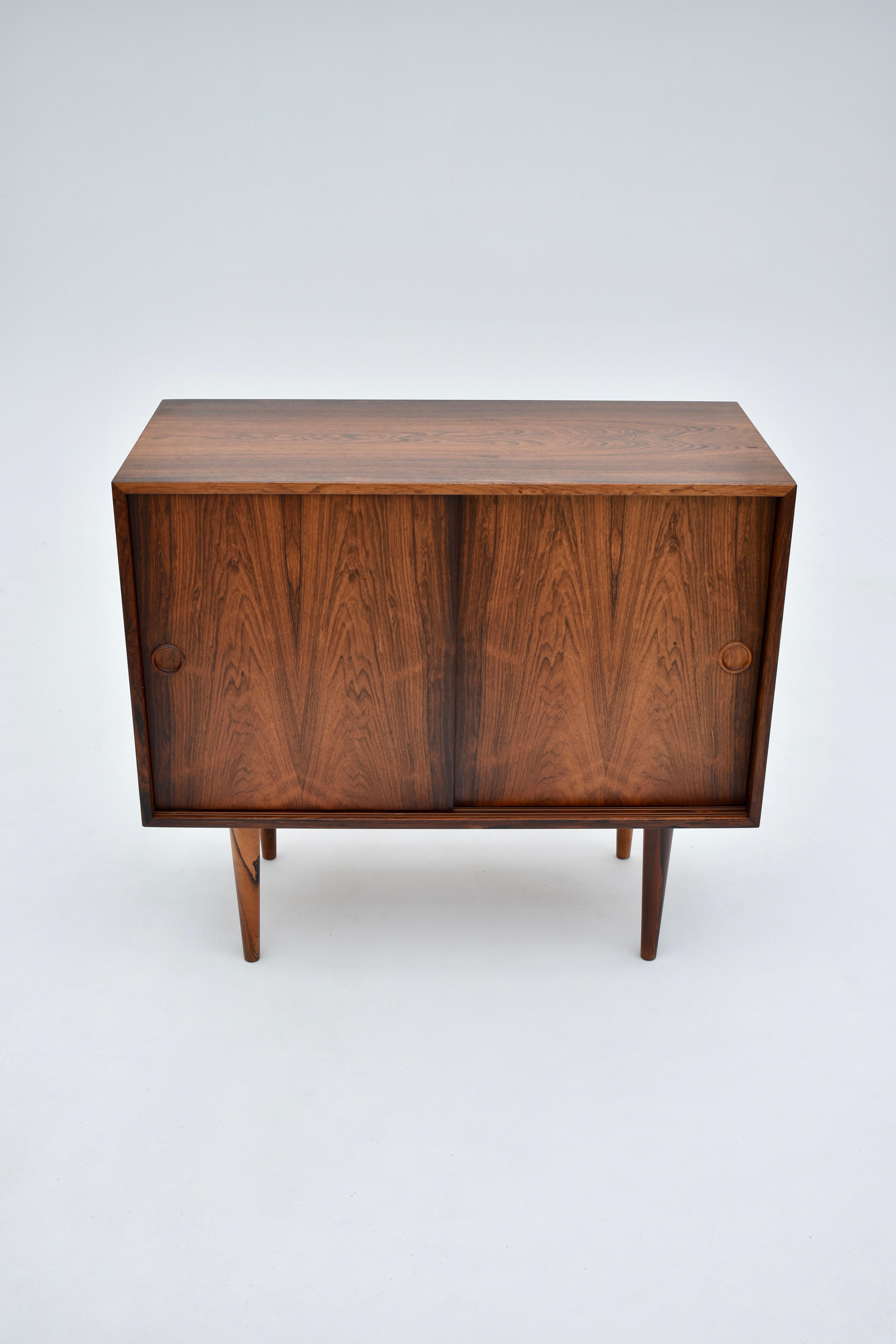 Beautiful little sideboard designed by Kai Kristiansen for Feldballes Mobelfabrik in the mid 50’s.

Very expressive Brazilian rosewood veneers to this example. The interior is also lined with rosewood. To the right two contrasting Maple drawers