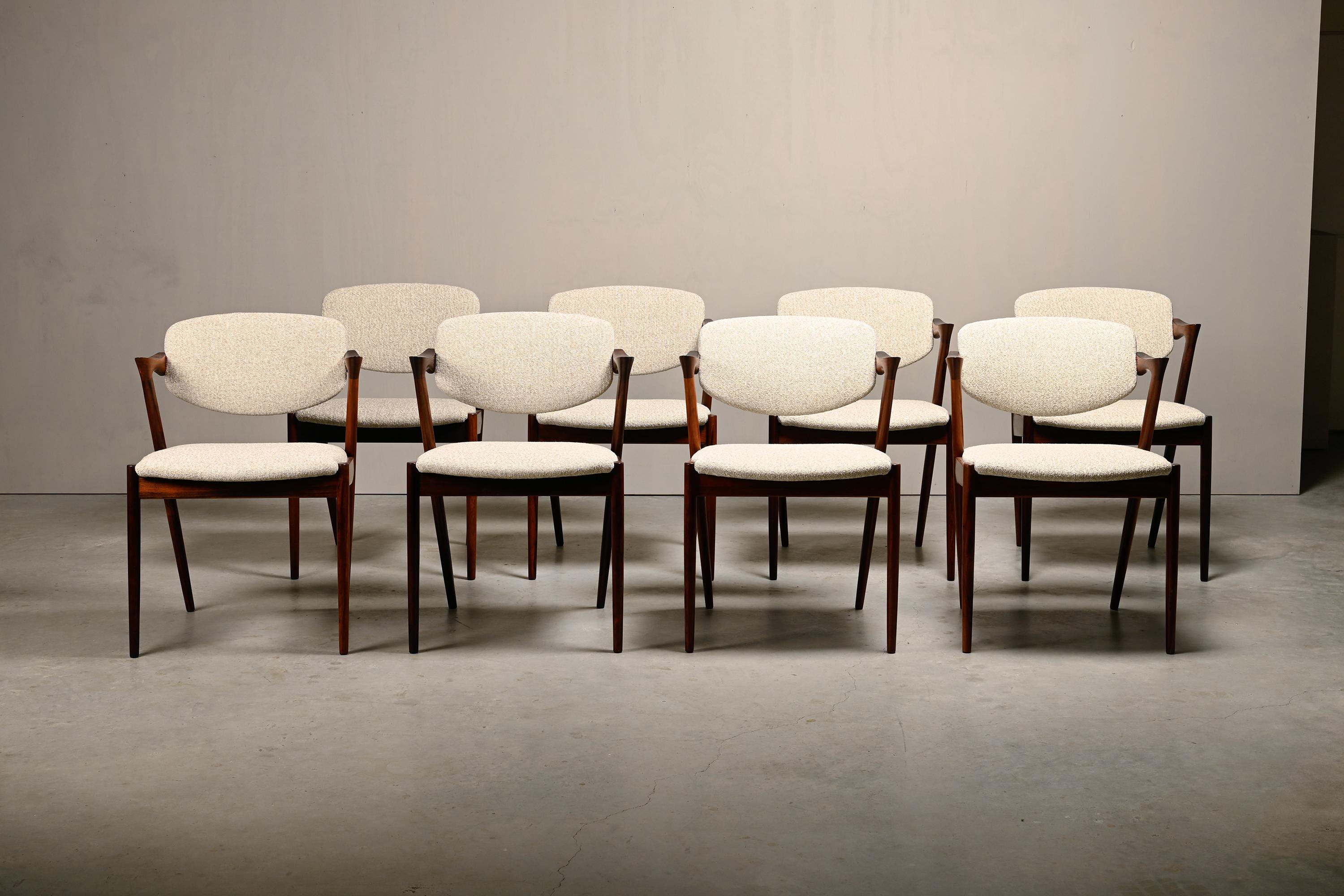 Elegant Kai Kristiansen Model 42 dining chairs for Schou Andersen Furniture, Denmark, 1960s. Beautiful rosewood frames and newly upholstered seats in a light blended fabric. In very good condition and ready for immediate use. The backrests are
