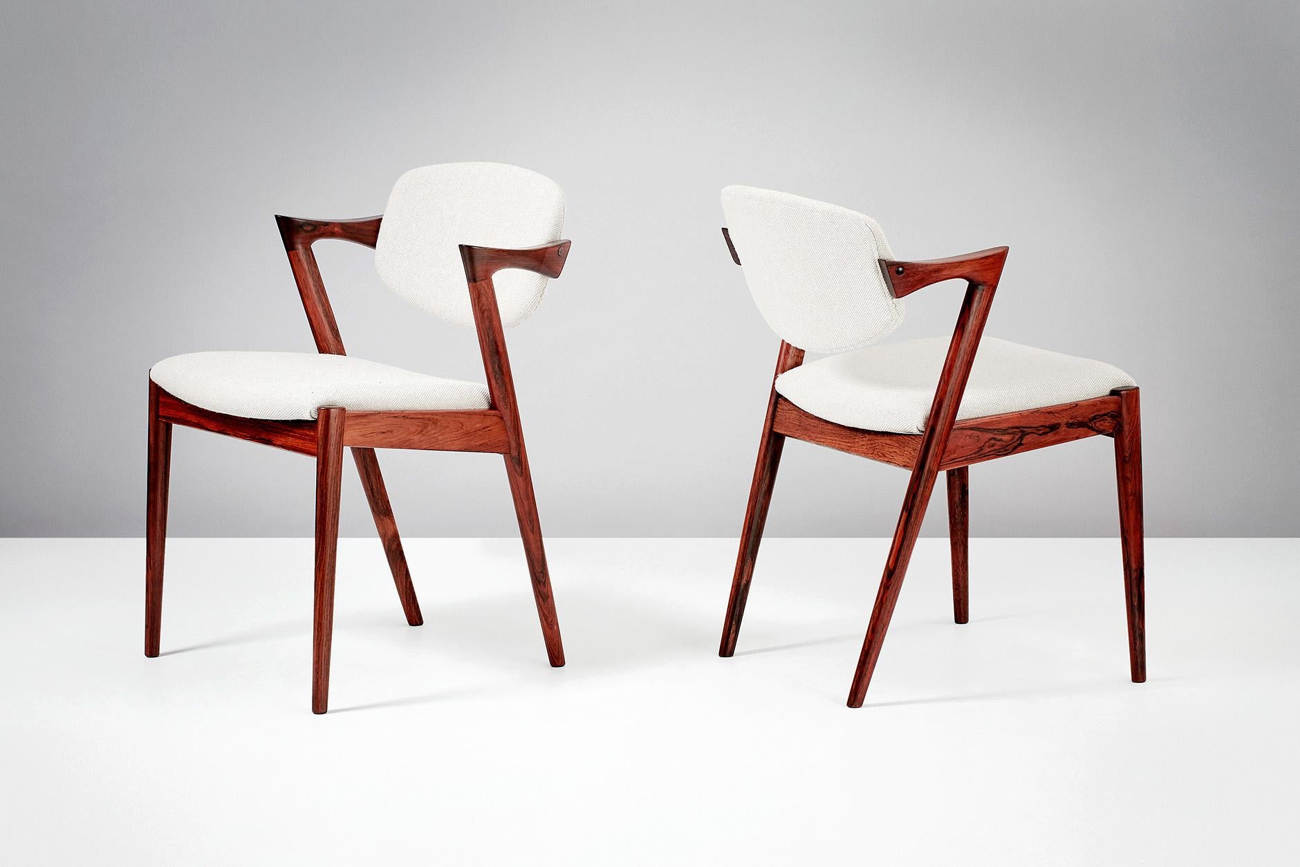Kai Kristiansen
Model 42 dining chairs, 1956.

Set of 8 dining chairs produced by Skovman Andersen for the Illum Bolighus department store in Copenhagen. Refinished rosewood frames with seat and back reupholstered with Kvadrat Hallingdal wool