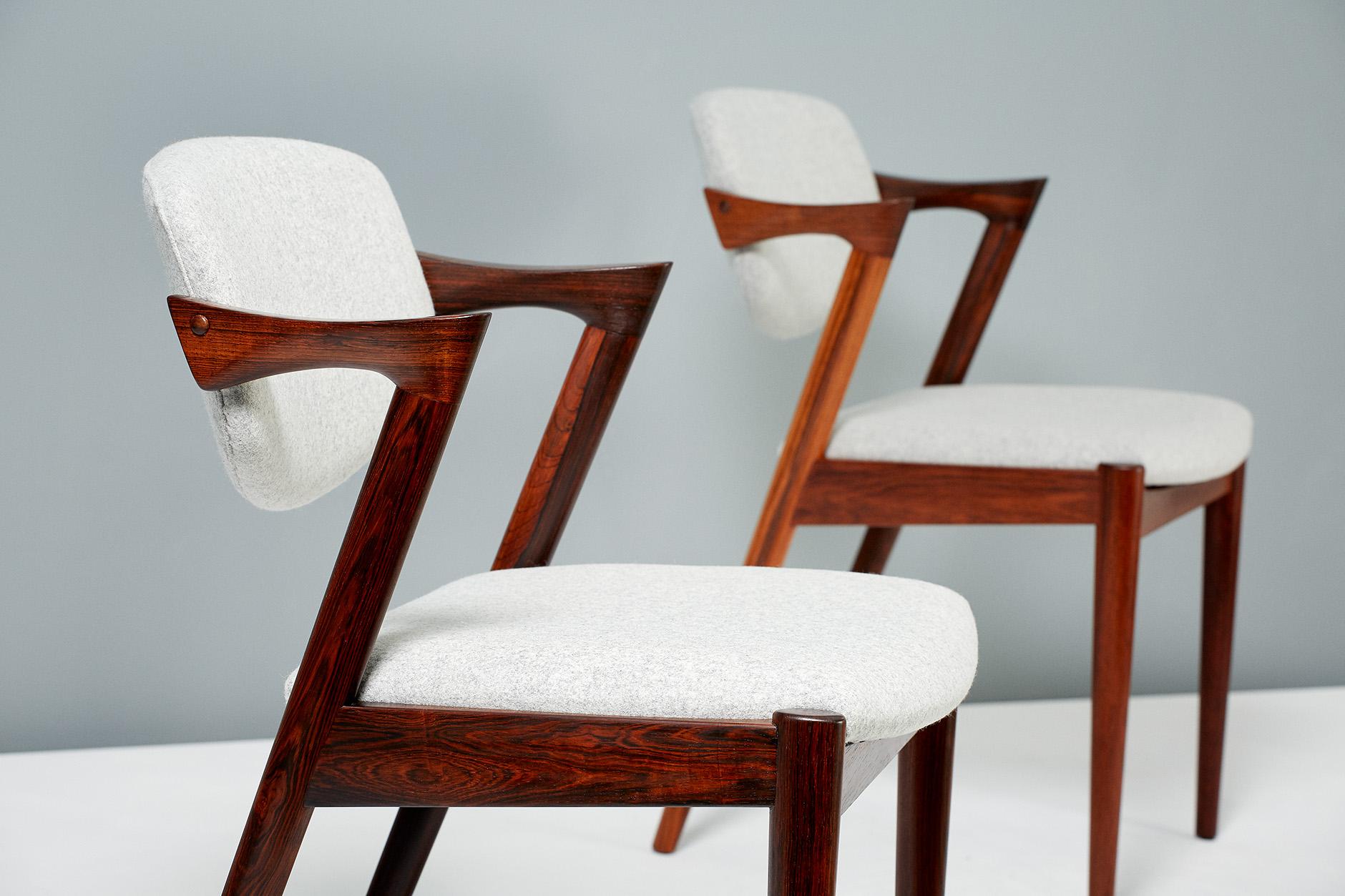 Kai Kristiansen
Model 42 dining chairs, 1956.

Set of 8 dining chairs produced by Skovman Andersen for the Illum Bolighus department store in Copenhagen. Refinished rosewood frames with seat and back reupholstered with Kvadrat Divina soft wool