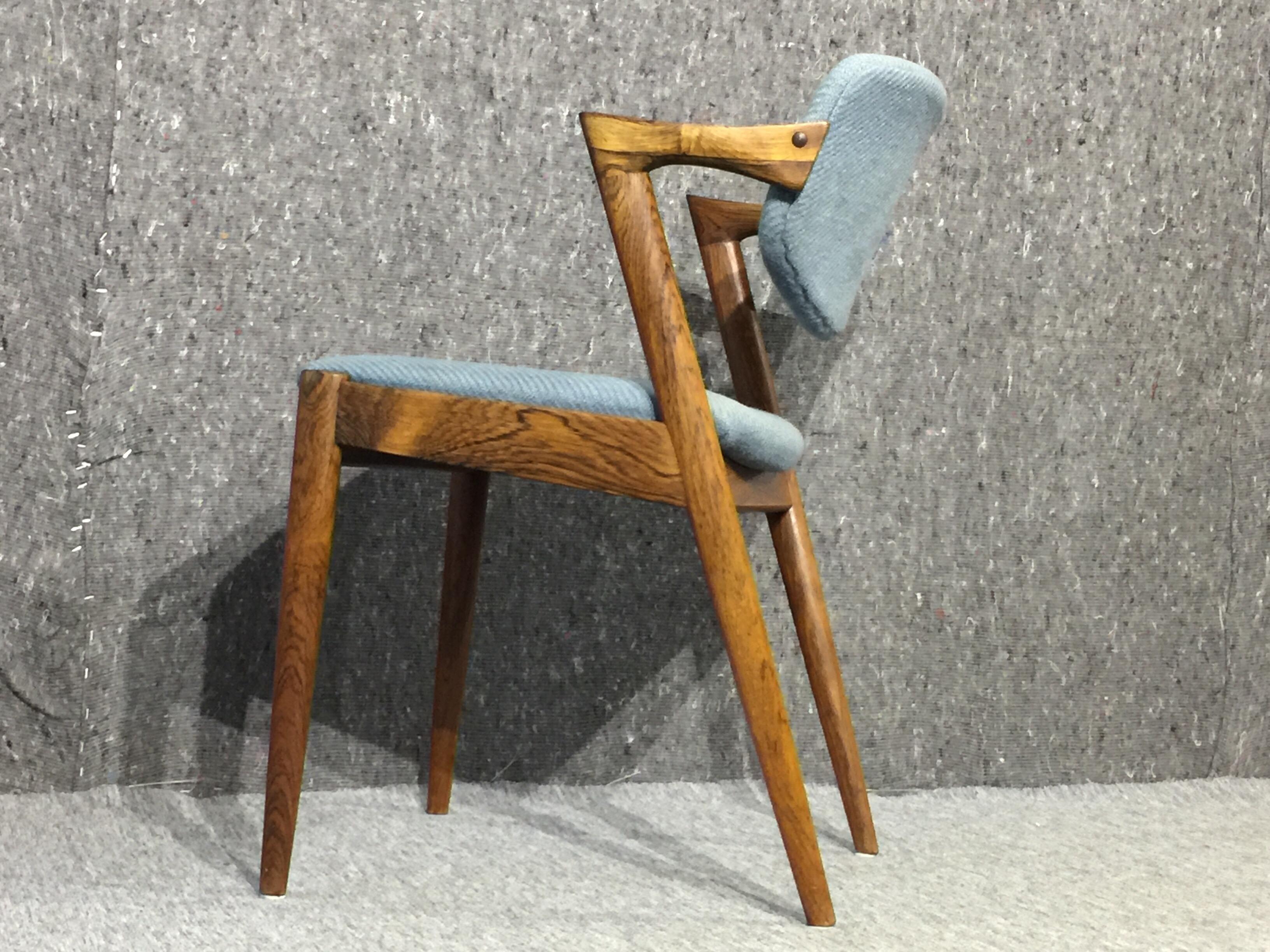 Set of four rosewood dining chairs, model 42, designed by Kai Kristiansen for Schou Andersen in the 1960s. They have a Z-shaped armrest and a suspended backrest. This model has become an icon for Kai Kristiansen's design. They will look amazing in